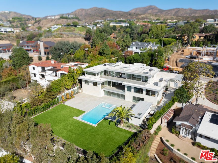 A striking architectural achievement where expansive living meets coastal tranquility. This newly remodeled from top to bottom, three-story residence redefines modern luxury with 5bedrooms (which can be converted into 7) and 8 bathrooms and over 1,200 square feet of balconies and covered loggias designed to capture the Pacific breeze and sweeping ocean vistas. Floor-to-ceiling glass doors throughout the home dissolve the boundaries between interior and exterior, inviting natural light to dance across hardwood floors and illuminate the home's open, flowing floor plan. The heart of the home unfolds on the main level, where a generous living room features an intimate reading nook nestled beside a fireplace- ideal for quiet mornings. The expansive family room flows effortlessly from the kitchen, creating an intuitive space for daily living and grand-scale entertaining alike. Two large suites can be converted into three, plus an office if desired. Ascend to the upper level, where each ensuite bedroom is a private sanctuary with direct access to a sprawling ocean-view patio with its own fireplace. His and hers primary bathrooms each with ocean view and walk-in closets. Witness the sun melt into the Pacific- all from the comfort of your own retreat. The ground level unveils an entertainer's dream: a sophisticated screening area opens directly to the resort-caliber backyard, where a sparkling pool, spa, and expansive entertaining patio await. The detached pool cabana- complete with bathroom-offers flexible space as a seventh bedroom, guest suite, gym, or creative studio. The grounds are equally impressive: a substantial flat yard with generous grass areas provides endless possibilities for children and pets to explore, while lush landscaping provides serenity. Three car garage and on-site parking and room for kids to skateboard and bike around. This is more than a home- it's a lifestyle. Moments from Palisades Village, world-class beaches, and the vibrant dining and culture of the Westside, this residence offers the rare combination of serene privacy and effortless access to coastal California's finest offerings. *The 357 square foot pool cabana not included in total square feet.*