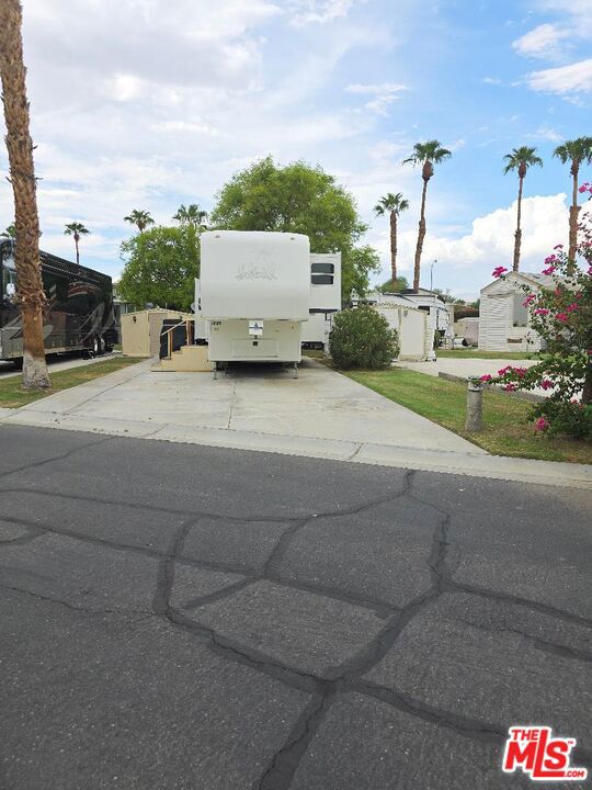 This is a back in lot, close to the main entrance and main clubhouse and pool. It is also, close to satellite A pool and services. It backs up to a green belt, to give you a bit of extra common grass area. The shed on the lot offers a bit of extra space for storage. This lot is zoned for to add a park model, with community approval. This all located in a 55+ community that has a 3 par golf course, chipping green, putting green, 9 hole mini golf, pickleball and tennis courts, bocce ball, an indoor shuffleboard courts, 2 clubhouses with pools and jacuzzies and an additional 4 satellites with pool, jacuzzies and mail boxes. This is all within a 24 hour gate guarded community of 801 lots, that consist of a combination of Park Models and RV lots, where you own the land. The resort has a limit of 270 day occupancy. It is a perfect place to spend your holidays in the sunshine. (NOTE: pictures show with RV, this RV is not included in sale.)