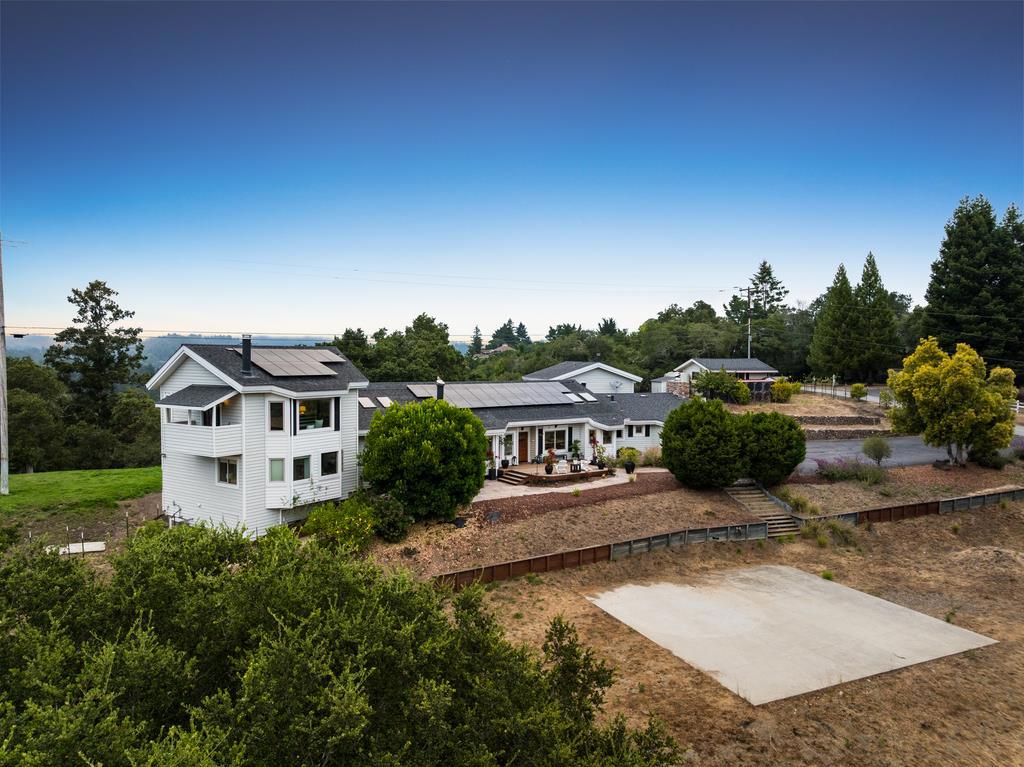 You know that ridgetop home where you can see everything? The one with unparalleled views that make you feel like youre on top of the world? You wake up and have coffee on the balcony overlooking the entire valley. The kids are already racing to get eggs from the chicken coop while your house guests are waking up in their own private unit. Everyones got space, but nobody feels disconnected. Your family just spreads out naturally, someones relaxing in the great room, the kids disappear to spend hours in the game room, and youve got the perfect spot waiting to become whatever sports court your family wants. Basketball, pickleball, tennis, whatever gets the family together. Nights are spent telling stories and laughing while you roast s'mores over the firepit. When your extended family visits, they genuinely dont want to leave. Theres room for everyone to spread out comfortably. A short drive puts you close to Soquel restaurants, but with sunset views like this, youll never want to leave. This is the kind of place where you stop looking at real estate apps because you already found what everyone else is searching for.