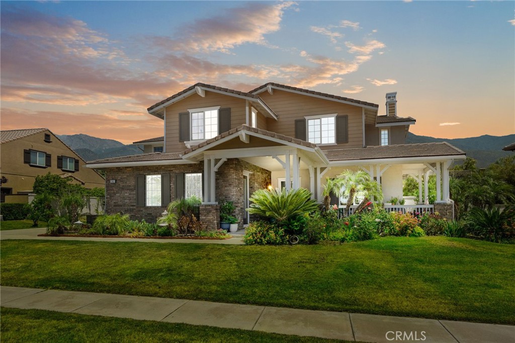Welcome to 13812 Breeders Cup Drive — a stunning and spacious estate nestled in the prestigious foothills of Rancho Cucamonga. This beautifully maintained 6-bedroom, 6-bathroom home offers the perfect blend of luxury, comfort, and privacy, with a versatile layout ideal for multi-generational living.As you arrive, you’re greeted by pristine landscaping, a charming front porch, and a striking brick-and-stucco elevation framed by mountain views. Step inside and experience an elegant interior featuring rich hardwood floors, intricate crown molding, and a grand foyer with custom tray ceilings and architectural detail throughout.The home’s thoughtfully designed floor plan includes a private mother-in-law suite with its own bedroom, bathroom, and living area — ideal for extended family or guests. The main living areas are expansive and full of natural light, with warm wood accents, arched walkways, and a stately staircase that adds a touch of sophistication.The chef’s kitchen (not pictured but assumed) flows seamlessly into a spacious family room, perfect for entertaining. Every bedroom is generously sized, and all bathrooms are tastefully appointed with granite countertops, updated fixtures, and tile work.Outdoors, enjoy a peaceful and lush backyard setting, beautifully landscaped and perfect for relaxing or hosting gatherings under the California sky.Located in one of Rancho Cucamonga’s most desirable neighborhoods, this home is close to award-winning schools, scenic trails, shopping, and more.