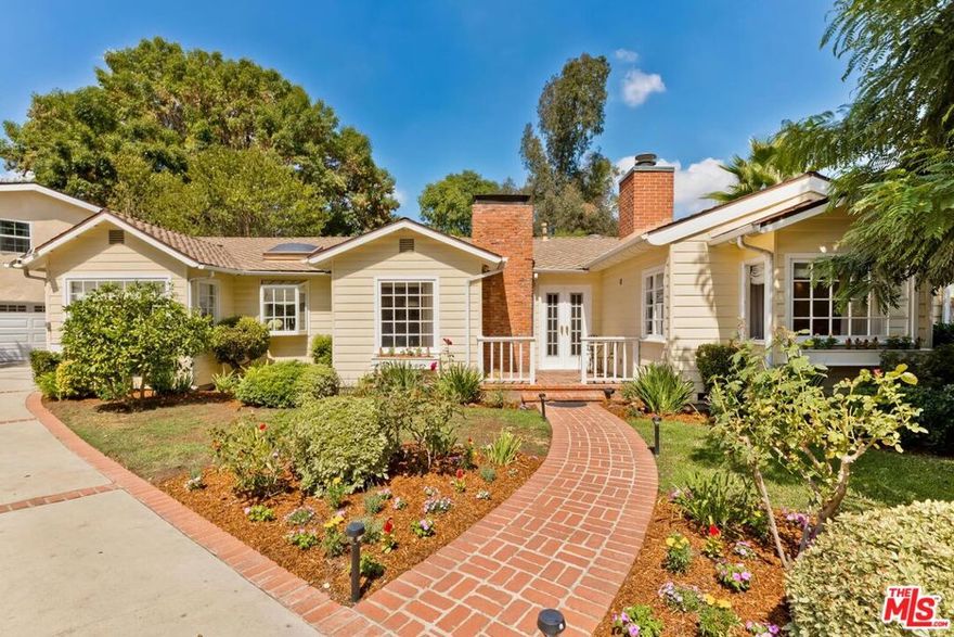 Welcome to a private retreat In Studio City's most coveted Woodbridge Park with a separate guest house, pool and spa.  Tucked away at the end of a quiet cul-de-sac, on one of the largest flat lots in this most desirable neighborhood, a gated single level residence offers the perfect blend of elegance, comfort and privacy.  The long, gated drive leads to this  beautifully remodeled two-bedroom, two-bath main house with a flowing, light filled floor plan from skylights and oversized windows that fill the home with natural light, creating a warm and inviting atmosphere.  There are four fireplaces throughout the home, adding to its allure as a fine gathering place.  At the heart of this charming home is a chef's kitchen that will impress even the most discerning buyers, featuring high end appliances, custom cabinetry, an oversized center island for dining, built-in banquette seating and a cozy lounge area ideal for entertaining.  The primary suite has a double-door entry leading to a spa-inspired bath, dual closets, step-down bedroom with a vaulted ceiling and French doors that open to the rear yard, spa and a sparkling salt water pool with a tranquil rock waterfall.  A bright and charming guest bedroom at the other end of the hall includes custom built-ins, a vaulted ceiling, window seat and access to a stylish second bath.   The lushly planted rear yard functions as a resort-style oasis perfect for entertaining and for peaceful, quiet relaxation.  A detached guest house, which is permitted as an ADU, adds incredible versatility - ideal as a private suite for visitors, home office, creative studio or fitness space.  This rare offering combines upscale finishing, understated luxury, thoughtful design and the best of indoor-outdoor living, situated in one of LA's best pockets to enjoy a strong sense of community, connection to neighborhood traditions, top-rated schools and a close proximity to fabulous Tujunga Village restaurants, cafes, coffee shops and boutiques.
