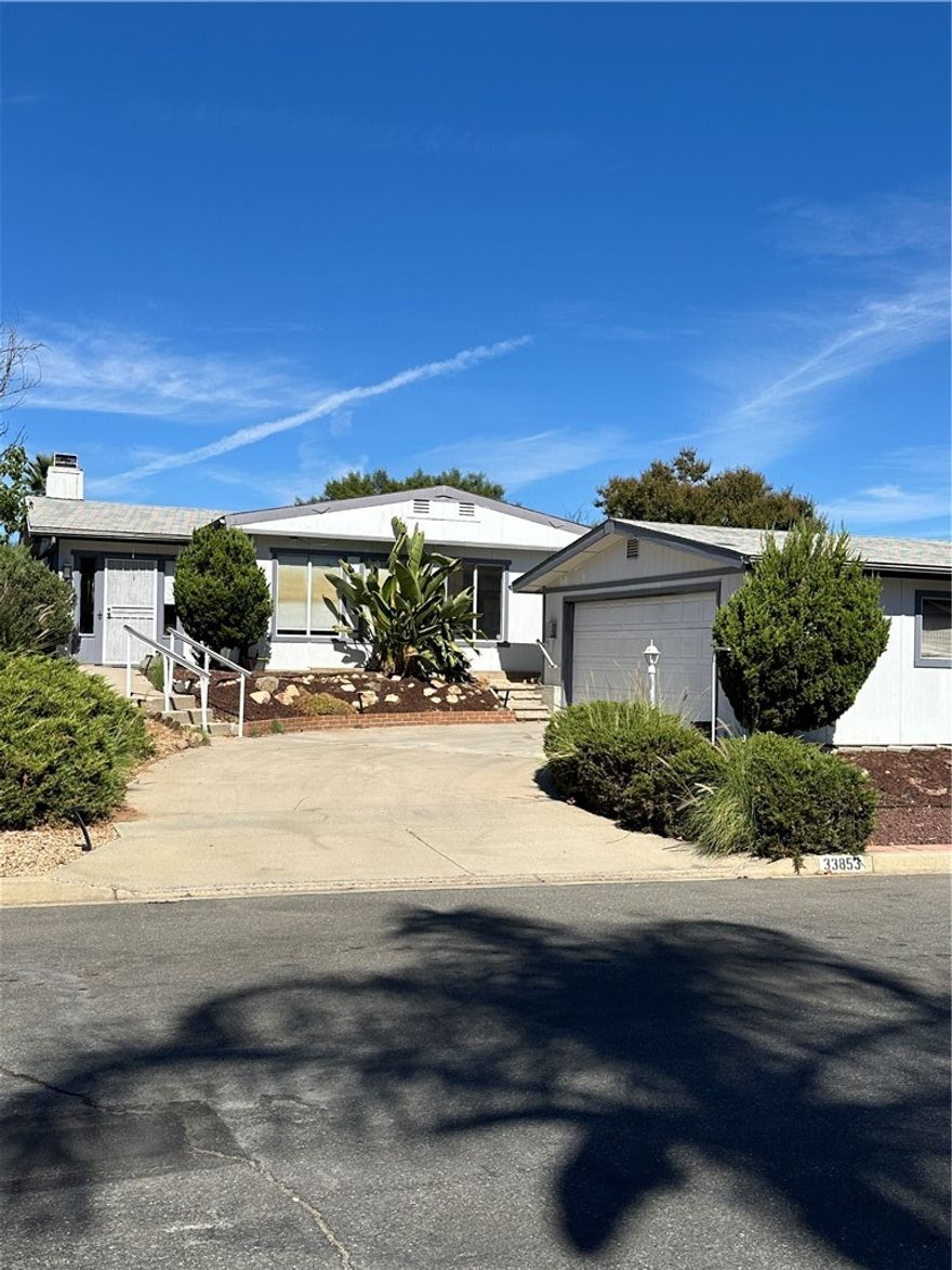Great starter home or income property awaits in the lovely community of The Farm. This large triple-wide 2-BR manufactured home resides on a large lot that backs directly to an orange orchard where fruit is readily available to residents any time, fresh OJ every morning when in season. The kitchen was updated in 2017 but otherwise ready for you to customize to your preference. The sizeable low-maintenance lot conveys with the home, not on leased land like other parks. This large community with low HOA fees includes 600 Acres of Common Area includes 38 Acres of Citrus Groves, 3 Pools, 2 Spas, a Pond for Fishing (Catch & Release), Game Fields, a Basketball & Tennis/Pickleball Court, low-cost boat and RV Storage Areas, Hiking Trails, a Picnic Area and 2 Tot Lots. Enjoy easy access to the 15 and 215 freeways. Come see one of the last vestiges of affordability in this lovely community. Low-cost boat and RV STORAGE! @ 59$/mo