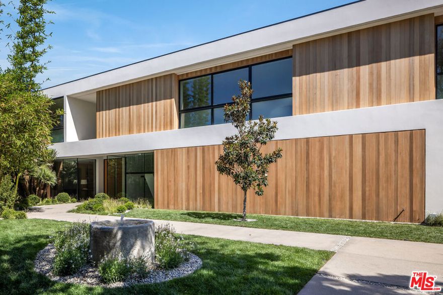 An exceptional compound on Bel Air Road with magnificent water views. Tucked away behind gates, a serene escape, in the heart of the city, creating a harmonious blend of modern luxuries with a natural surrounding. This Contemporary home, built new in 2017 and recently updated, offers privacy and views rarely seen in Los Angeles. Featuring a seamless indoor and outdoor floor plan as well as ample living spaces both upstairs and down. The amenities deliver a resort-like environment, with a flowing kitchen and separate chef's kitchen, oak floors, stone walls, and more. The home offers 4 bedrooms upstairs and one down, theatre, wine room, gym/yoga studio, and separate guest house. The outdoor dining, lawn, and edgeless pool effortlessly blend the property with its landscape. The estate also features two double garages, a large motor court, and a thoughtfully designed sanctuary garden entrance.