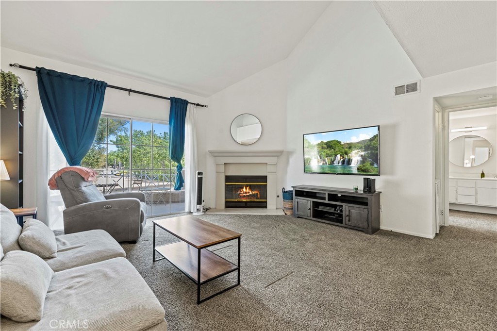 Welcome to this beautifully updated dual primary suite condo in the highly desirable Santa Fe community of Valencia, complete with a detached 2 car side-by-side garage. Step inside to discover soaring ceilings, fresh finishes, and an open-concept living space filled with natural light. The spacious living room features a cozy fireplace and sliding doors that open to a private patio, perfect for morning coffee, barbecues, or unwinding outdoors. The thoughtfully designed floorplan offers two large primary bedrooms, each with its own en-suite bathroom and walk-in closet, providing comfort and privacy for residents or guests. The updated kitchen showcases granite counters, stainless steel appliances, and ample cabinet space, making it both stylish and functional. Additional highlights include convenient in-unit laundry and an excellent location as a corner unit! Situated in the heart of Valencia, this home offers unbeatable walkability to dining, shopping, and the Valencia Town Center, with quick access to freeways for commuters. The Santa Fe community provides resort-style amenities including multiple pools, spas, and access to the famous Valencia paseo system for biking, jogging, or evening strolls. With no Mello-Roos and HOA that includes water and trash, this condo is a perfect blend of value, comfort, location, and move-in ready and waiting for its next owner!