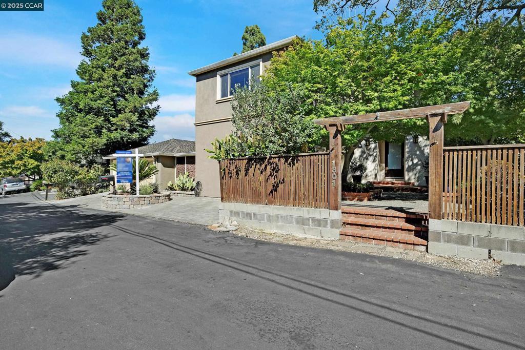 Welcome to this stunning residence, perfectly positioned near town and showcasing breathtaking views. It offers a rare combination of generous space, timeless charm, and picturesque surroundings. Featuring 4 bedrooms, 2.5 bathrooms, 3,126 square feet of living space, the property spans two separate lots that provides privacy and a peaceful hillside setting. From its elevated position, the home enjoys gorgeous panoramic views of Mt. Diablo, the city below, the bridge and the water, creating a stunning natural backdrop that enhances everyday living. Step through the inviting entry into a bright and thoughtfully designed interior filled with natural light. The open floorplan flows seamlessly, with both a formal living room and a comfortable family room, each with its own fireplace, offering warm and welcoming spaces for relaxing or entertaining. The kitchen is centered around a large island and features modern appliances, making it ideal for both daily use and hosting. Outside is a true oasis showcasing a relaxing spa, patios, decks, and mature landscaping that complements the home’s timeless architecture. The hillside location not only provides breathtaking views but also places you near top-rated Martinez schools, local parks, and scenic trails.