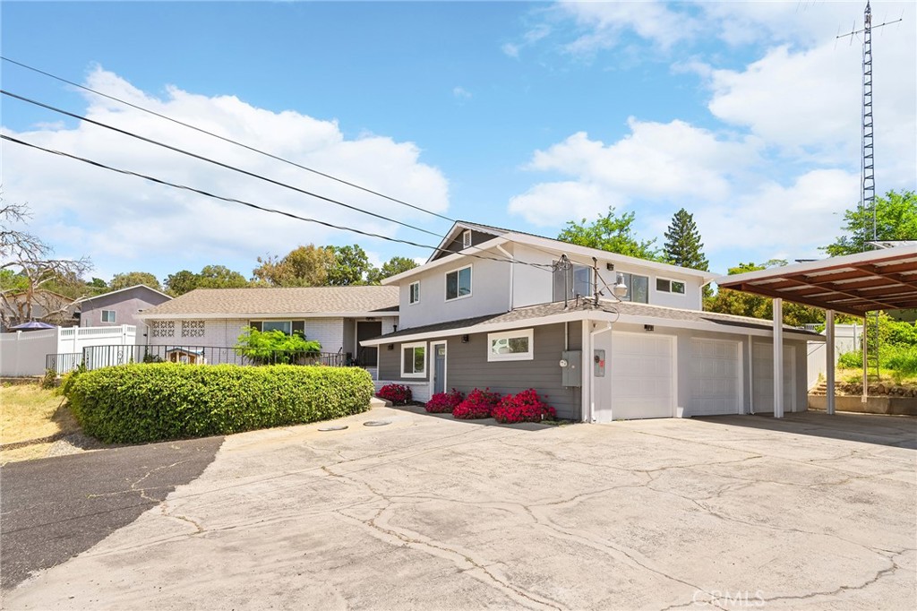 Welcome to this unique 2,575sqft tri-level home with owned solar and a pool that perfectly blends comfort, functionality, and fun. Nestled in a peaceful setting that still offers easy access to shopping, restaurants, and the Oroville Lake & Dam, this property offers the best of both worlds—privacy and convenience. As you walk into the living room you're met with cathedral ceilings, a cozy fireplace, and dual sliding doors which offer tons of natural light that open to a stunning backyard oasis. Enjoy a large in-ground gunite pool featuring a diving board, slide, and play structure with gazebo perched above for added charm. There's also a built-in BBQ area and a separate bathroom with a tile shower, offering direct access from the pool so guests don’t need to enter the home. The kitchen boasts tile countertops, a breakfast nook, and a walk-in pantry, complimented by stainless steel appliances that are included and just off the kitchen are stairs leading down to a private lower-level retreat. There, you'll find the primary suite connected to a second room—ideal for an office, gym, or nursery—both with closets and a separate entrance for added privacy or potential multigenerational living. This level also includes a large utility/laundry room, plus access to the garage.Upstairs offers three additional bedrooms with amble storage and closet space, including one bedroom with direct bathroom access—perfect for guests or older children. This property also features a generous 3-car garage, a sizable covered carport with RV access and hookups, plus an attached storage unit complete with a loft—perfect for all your storage and organization needs. Not to mention this home is also fully fenced with new vinyl privacy fencing. Whether you’re relaxing by the pool or entertaining under the stars, this home delivers on lifestyle. Don’t miss this rare find—country feel with city convenience!