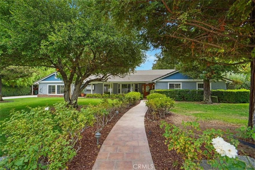 Nestled in a serene, parklike setting, this spacious custom SINGLE STORY Hasley Canyon 4-bedroom, 3-bath ranch-style home sits on nearly an acre of beautifully landscaped grounds. Oak hardwood floors welcome you through the entry, main hallway, and kitchen. The chef’s kitchen features granite countertops, a 5-burner cooktop, double ovens, trash compactor, dishwasher, and microwave—perfect for cooking and entertaining. Formal dining room just off the kitchen. The family and living rooms are separated by a unique double-sided fireplace—gas on one side, wood-burning on the other—with a convenient wet bar in between. Both rooms open with French doors to stunning backyard views. The primary suite offers a generous layout with French doors leading to the rear porch, a walk-in closet with built-ins, and a primary bath including soaking tub, walk-in shower, and dual sinks. Three large secondary bedrooms have ample closet space. A separate laundry area adds convenience. Interior has been freshly painted (August 2025). Large attached three car garage with built in cabinets and epoxy floors - lots of storage! Covered carport off the garage can fit up to four cars. Out back, enjoy the long covered porch overlooking lush landscaping, garden areas, a greenhouse, and a powered storage container. Great cul-de-sac location close to necessities and freeway access, yet far enough away for amazing privacy! With almost an acre of land, this property blends privacy, functionality, and natural beauty. MUST SEE!