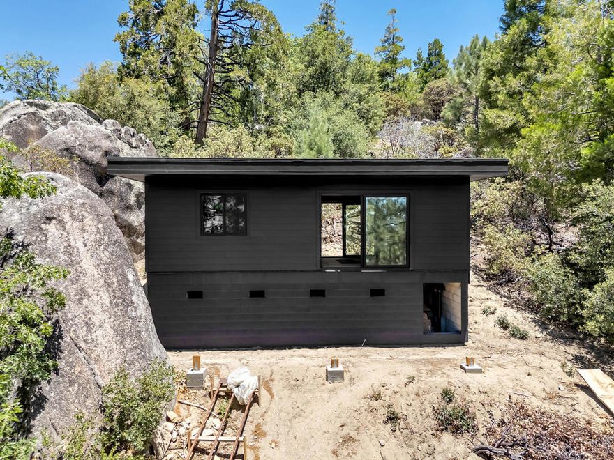 Opportunity awaits in beautiful Idyllwild! This property includes a 392 sq ft tiny home in the course of construction perfect for buyers ready to take on a rewarding project. The site features completed septic, approved plans, and water on the property. Electrical and plumbing are in progress, and a power pole is on site for convenient hookup. No certificate of occupancy has been issued, and the property is being sold as is. Backing up to State land with direct access to nature, the site is positioned to take in spectacular mountain and treetop views. A rare chance to finish and personalize your own peaceful retreat just minutes from town! Don't miss this opportunity, bring your vision and make it yours today!