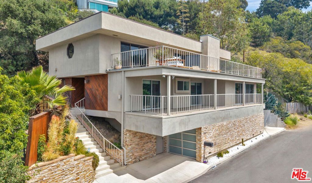 Welcome to this stunning modern estate in the heart of Crestwood Hills, Brentwood. Spanning two levels, the home boasts sweeping city and ocean views. The expansive primary suite includes a spa-like bathroom, spacious walk-in closets, and a serene sitting area. Enjoy an open-concept living room, a designer chef's kitchen, and multiple oversized decks perfect for soaking in the scenery. The outside decks are ideal for sipping your morning coffee or dining al fresco, creating a seamless blend of comfort and sophistication. Whether entertaining guests or watching the sunset, this home offers the ideal setting for elevated living.