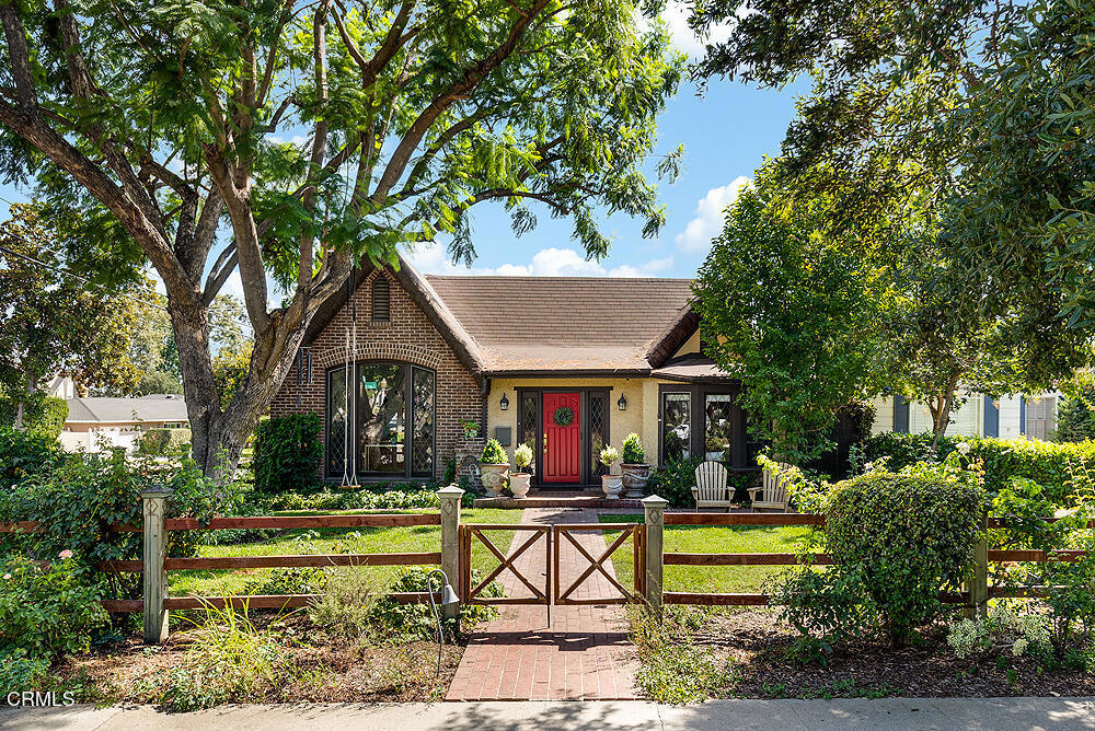 Welcome to this exquisite 1926 English Tudor on one of Pasadena's most desirable streets, Lambert Drive! This fully remodeled home features 3 bedrooms & 2 bathrooms, hardwood floors, custom cabinetry & custom window treatments throughout. Nestled among landscaped beds & Boston Ivy vines, the home has leaded glass windows, a brick facade, & its rolled original roofline. The entryway showcases arched openings leading into the formal dining room & living room. The dining room features a coved ceiling & wrought iron chandelier, with matching sconces. The living room features a leaded glass front window with mountain views, barrel ceiling, & a Batchelder fireplace. The built-in breakfast nook anchors the chef's kitchen & includes a dry wine bar, custom walnut cabinetry, Taj Mahal quartzite countertops, pantry, & top of the line appliances, including a 6-burner Wolf range with griddle & double oven, warming oven, built-in Subzero refrigerator/freezer, Subzero wine refrigerator & microwave. The kitchen was completely gutted & rebuilt from the ground up with carefully selected, top-quality fixtures, hardware, lighting & finishes. The result is a warm and timeless space that balances traditional style with modern functionality, all in a natural earth tone palette. The 3rd bedroom showcases a built-in alcove & ceiling fan. This room leads to the primary suite with an oversized closet, double-pane windows & its own A/C unit. The primary bath is a bright 3/4 bath that features a dual vanity & an oversized shower. Designed to complement the home's 1926 English Tudor Revival architecture, the 2nd bath was renovated with a timeless black-and-white scheme including basketweave black & white heated floors, Soapstone counters, marble tile, & new faucets. The spacious 2nd bedroom features a double closet & barn doors that lead to the laundry room. High-end finishes continue with a large laundry/utility room with washer/dryer & lots of storage. The laundry's double French doors open to the backyard patio that is perfect for entertaining & a quaint grassy area with an above ground hot tub, bordered by a custom trellis with active grapevines. Upgrades include: copper plumbing, two 5-ton A/C units, tankless water heater & upgraded dual-pane Marvin windows. There is also a detached 2 car garage with extra storage & a large CA basement that can become a wine cellar. This newly updated architectural home has every tasteful finishing touch & is ready for you to move right in!