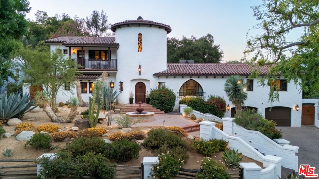 Welcome to this breathtaking Spanish-style 4-bedroom, 4-bathroom estate nestled on half an acre in the heart of Studio City, just moments from the scenic Fryman Canyon hiking trail. This expansive home is bathed in natural light, featuring soaring ceilings and exquisite custom tiling throughout. The open-concept kitchen, living, and dining areas create the perfect flow for both everyday living and entertaining. Warm up by one of the four fireplaces, including a stunning one in the luxurious primary suite, which also boasts a private balcony, massive walk-in closet, spa-like en-suite bathroom with a soaking tub, steam shower, and dual vanities. Step outside to a beautifully landscaped backyard, designed for ultimate relaxation and entertaining. Enjoy a custom-built pizza oven, Green Egg smoker, and built-in BBQ grill, ideal for summer nights and memorable gatherings.Additional highlights include a 2 -car garage. A true masterpiece of Spanish elegance and modern comfort don't miss the opportunity to make this exceptional home yours!