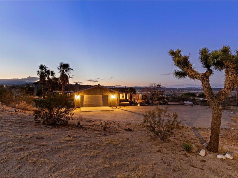 If you know - you know - incredible price , well below market. Successful Vacation Rental. Unfortunate circumstances for Seller make this your Best Buy! Property is a short sale and will require Bank Approval. Process started and just looking for your offer to get it done! Beautifully updated 4-bedroom home in coveted Panorama Heights neighborhood of Joshua Tree with loads of amenities! Boasting an artist's studio, media / game area, views of the park and more! Enter to a bright, stylish, open-concept living area with vaulted ceilings, oversized living room, formal dining area with beautifully tiled fireplace, and huge kitchen with large island and bar seating. The primary bedroom is over-sized with plenty of room to unwind. Enjoy the en-suite bath with a spa-like tub, separate shower, and walk-in closet. Each of the 3 guest rooms are amply sized with outdoor patio access. The RV garage has been transformed into a giant entertainment space. And you still have a 2-car garage to park in! Unleash your creativity in the sprawling artist's studio or unwind by the shaded olive trees and take in the serene views of the Mojave Desert at every turn. This 1.14 acre property is well landscaped and walking distance to Joshua Tree National Park.