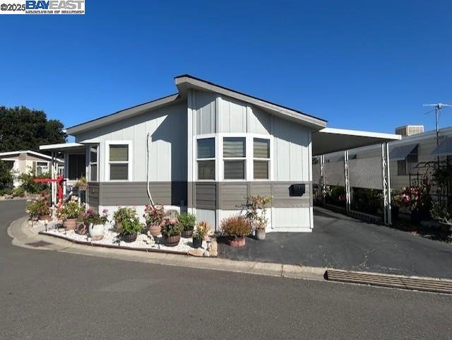 Lovely manufactured home in Hayward Mobile (adult 55+ park) features: 2 bedrooms; den; 2 full baths; living room with fire place and two cell clear story; spacious kitchen with island and nook area; indoor laundry room with washer and dryer; primary bedroom with walk in closet and private glamour bath with soaking tub and separate stall shower; large enclosed porch; corner lot, large custom shed & more. Fireplaces: GAS,GSR,LIV,