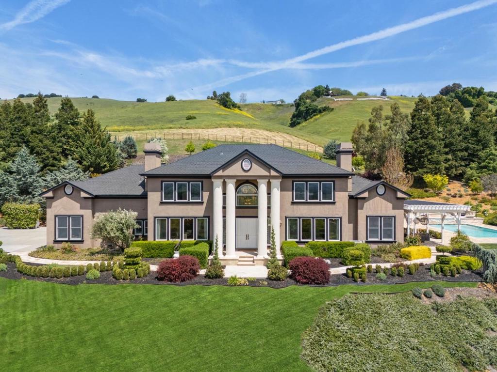 A Vision of Luxury. A Retreat with Purpose and Privacy. Whether you're seeking a serene corporate retreat or a magnificent place to call home, this exceptional estate delivers on every level. Tucked into the rolling eastern foothills of Gilroy and perched along the Southern Santa Clara Valley Wine Trail, this gated community offers unmatched privacy, prestige, and natural beauty. A private lane leads you to a residence designed to impress. With breathtaking panoramic views, the home blends timeless elegance with modern comfort, to include beautiful high ceilings, and in most cases, 8-foot tall doorways. You'll enjoy two luxurious primary suites (one upstairs, one down), offering flexibility and privacy; A chefs kitchen outfitted with premium appliances; Resort-like custom pool and spa with travertine decking and cascading waterfalls; Bocce ball court, pergolas, fountains, and manicured gardens set the scene for both grand entertaining and quiet reflection. Enjoy the tranquility of wine country living with the convenience of being just minutes from Silicon Valley, major shopping, and key transportation, including San Martin Airport, a preferred alternative for private and corporate aviation. Isn't it time you loved where you live?