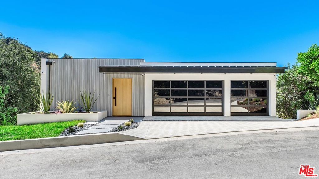 Located in the private and prestigious hills of Sherman Oaks, this newly constructed modern residence offers an exceptional blend of refined design, contemporary comfort, and seamless functionality. Encompassing four bedrooms and four bathrooms, this smart home is thoughtfully crafted to elevate everyday living and effortless entertaining, with sweeping canyon and city views as its backdrop. A true culinary haven, the gourmet kitchen is outfitted with brand new Thermador appliances, a sleek center island, and abundant custom cabinetry. The open-concept layout effortlessly flows into the dining and living areas, where floor-to-ceiling Kolbe windows and Fleetwood sliding doors invite natural light and create a harmonious indoor-outdoor connection. An electric fireplace adds warmth and ambiance, perfectly anchoring the living space. Descend via staircase or private elevator to discover a serene primary suite, complete with a luxurious balcony, spacious walk-in closet, and ensuite bathroom that feature a dual vanity, step-in shower, soaking tub, and private water closet. A secondary bedroom on this level also includes an ensuite bathroom and yet another balcony. The lowest level of the home presents two additional bedrooms that share a beautifully appointed bathroom, along with a versatile bonus room, ideal for a home office or entertaining space. A separate laundry room is equipped with built-in storage, a sink, and a generous counter space for added functionality. With convenient access to the Westside via Beverly Glen and just moments from shops and dining along Ventura Boulevard, this home embodies sophisticated California living at its finest. A rare opportunity to own a modern masterpiece in a prime Sherman Oaks location!