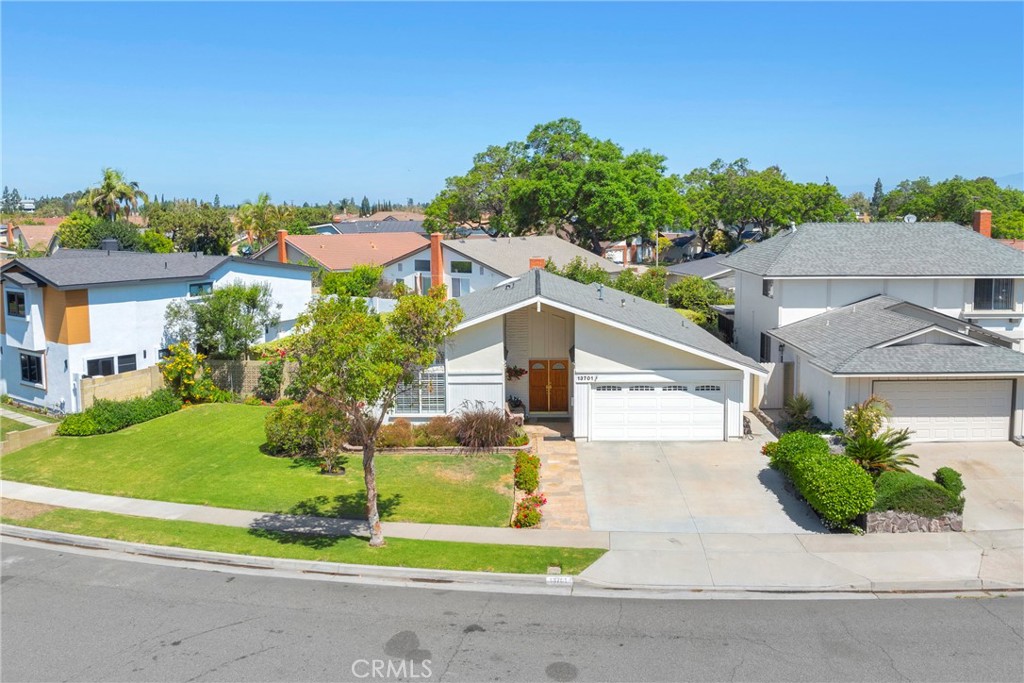 Welcome to your next chapter in the heart of Cerritos—where location, lifestyle, and livability truly come together. Perfectly set in one of the city’s most coveted neighborhoods, this highly desired single-story home delivers an ideal blend of comfort and opportunity. Offering 3 bedrooms, 2 beautifully remodeled bathrooms, and 1,846 square feet of thoughtfully designed living space on an oversized 7,517 square foot lot, you’ll enjoy room to live fully and even the possibility of adding the pool you’ve always dreamed of. From the moment you enter through the double front doors, the home makes an impression. The welcoming travertine tile entry and soaring vaulted ceilings create a sense of space and light that flows throughout. The updated granite kitchen seamlessly connects to the dining area and vaulted-ceiling family room with buffet style extended granite countertop, offering a central hub for everyday living and entertaining. The separated primary suite offers a private retreat, while two secondary bedrooms are ideally located off the living room, giving everyone their own space. Designer details and updates abound: travertine tile flooring, recessed lighting, window shutters, skylight, mirrored closet doors, ceiling fans, updated windows, and a statement fireplace that anchors the living room. Two double French doors lead you outside to your own personal sanctuary or to your family room. Step into the extremely private backyard, complete with an AlumaWood patio cover with motorized roll-down sun shades and elevated planter beds—perfect for gardening, entertaining, or simply enjoying the serenity. Beyond the property itself, Cerritos offers one of the best lifestyles in Southern California. Families are drawn to its award-winning schools, including Whitney High School, recently ranked the top middle school in California by U.S. News & World Report. The city is a thriving retail hub, and it’s well-known for its family-friendly parks, community programs, and cultural landmarks. This home is not just a property; it’s an opportunity to live in a city that celebrates connection, culture, and community. Schedule your private showing today and see why this Cerritos single-story is exactly where you’re meant to be.