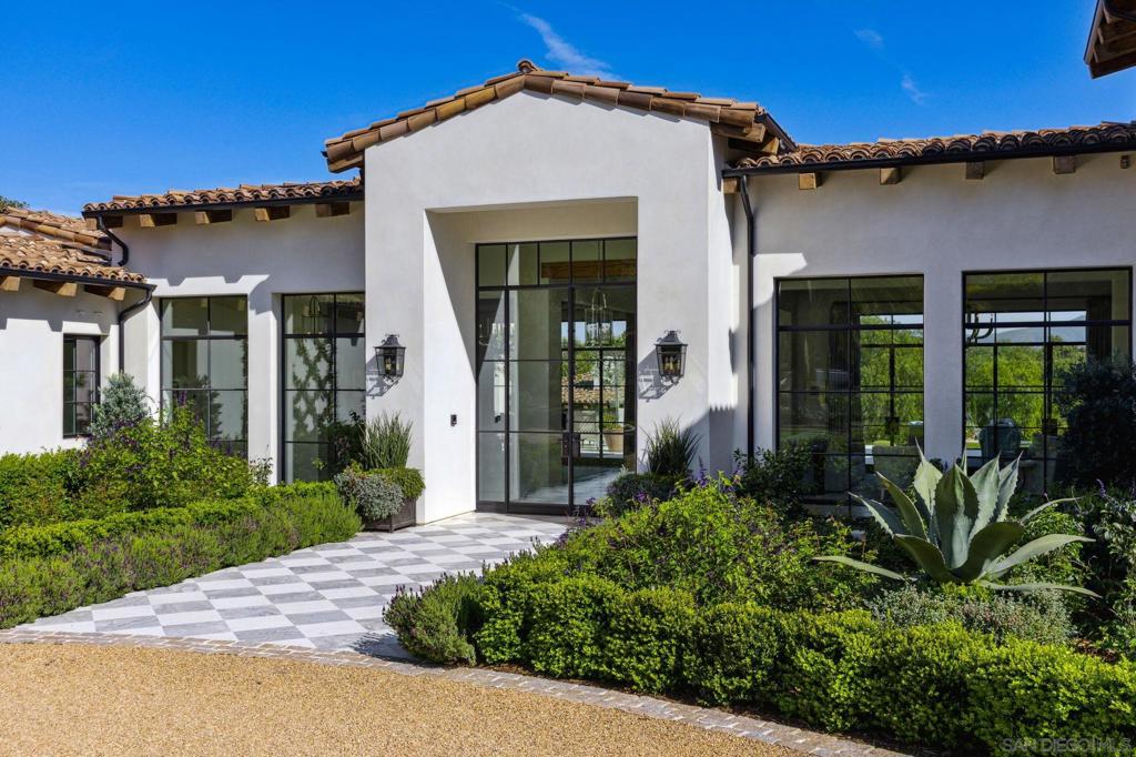 Welcome to your New Legacy! Custom BUILT in 2020!A level of luxury rarely seen. Nestled within 4.38 acres of meticulously manicured grounds, this RARE estate offers an exclusive lifestyle in premier Rancho Santa Fe Covenant with VIEWS! Unparalleled attention to detail, this 2020 masterpiece spans over 10,000 square feet of living space, boasting 6BDs and 7 full BTHs, 2 powder rms & featuring the timeless elegance of stone & wood flooring, w/ marble touches throughout. Entertain with finesse in the expansive great room, adorned w/ distressed wood beams & grand fireplace w/ seamless indoor/outdoor living. State-of-the-art gourmet kitchen features Habersham custom cabinetry, SubZero, 2 Calacatta marble counters, breakfast nook, large pantry and wet bar. Your lavish primary suite is complete with antique stone fireplace, vintage beam ceilings & relaxing spa-like bath, with boutique-style closets adorned with Habersham cabinetry & shelving. Outdoor lifestyle is perfect for al fresco gatherings under the stars with sprawling veranda, outdoor fireplace full bar, resort-style pool & spa. Improve your wellness at the fully equipped gym w/ full bath. Savant home system with surround sound & Tesla power walls. The compound is ideally located minutes to Golf and the Club and Village plus Rowe School with direct access to 60 miles of EQ, walking & running trails...long gated driveway, hidden from the street will make you feel right at home! Welcome to the pinnacle of luxury living!