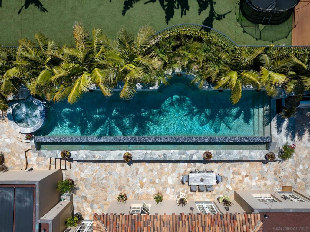 Romantic villa masterpiece, conceived in 2010, presents unrestrained beauty, craftsmanship and volume behind gates on a lot in excess of half an acre. Compound is surrounded by trees, pathways and tranquil gardens leading from a dramatic, two-story foyer and grand scale soaring ceilings that welcome. Two exquisite offices – one with coffered wood ceilings and access to pool and grounds - are set on the top floor along with living and sitting rooms, 3 interior fireplaces, a large, chef’s kitchen with stunning backsplash and top-of-the-line appliances including a pot warmer, oversized center island and breakfast room. The Primary suite with fireplace and seating area presents picturesque views beyond its three French doors and offers dual ensuite baths and closet-dressing rooms to lounge and ready with care and comfort. Four bedrooms and baths, a game room and a wood-paneled movie room comprise the middle floor. The bottom floor has three 1-car garages, a gym, the 6th bedroom and bath, and an elevator servicing all floors. The outdoors areas are truly dreamy, offering an infinity-edge pool and spa, a sports court, two exterior fireplaces and gathering areas. This estate home is truly a crown jewel of La Jolla.