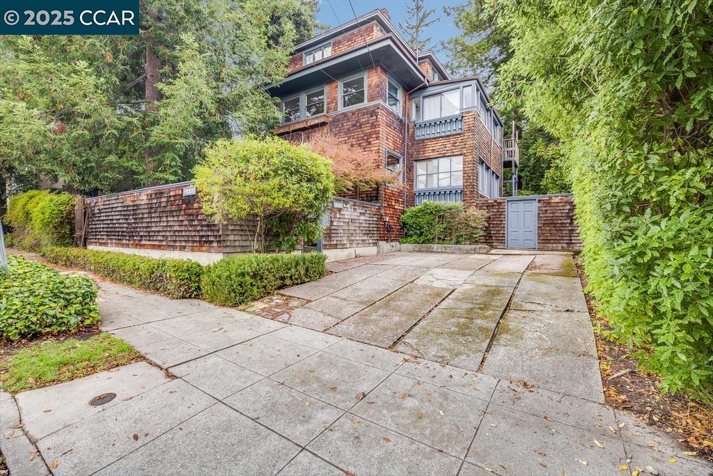 Historic Charm in the Heart of Elmwood. Step into this beautifully preserved Craftsman nestled in a tranquil, tree-lined setting w/in Berkeley’s highly sought-after Elmwood neighborhood. Situated on the 1st level of an attractive 3-unit brown shingle building, this home exudes timeless character & classic design. Inside, you’ll find spacious rooms enhanced by hardwood floors, high ceilings, stained glass windows, rich wood trim, & elegant pocket doors. The inviting living room features a wood-burning fireplace, the formal dining room—w/ built-in cabinetry—opens to a charming balcony. The kitchen blends vintage appeal w/ modern updates, featuring a generous center island w/ breakfast bar, newer appliances, floating shelves, & large windows that fill the space w/ natural light. A convenient laundry nook adds functionality. The grand bedroom offers a cozy retreat, while the sunroom—bathed in natural light—makes an ideal office, den, art studio, or guest room. Outside, enjoy a peaceful, park-like shared backyard shaded by towering redwoods—an oasis that feels worlds away yet is just minutes from UC Berkeley, Greek Theater, Julia Morgan Theater, College Ave shops & cafés, public transit & commuter routes. Add'l highlights: assigned parking spot & basement storage.