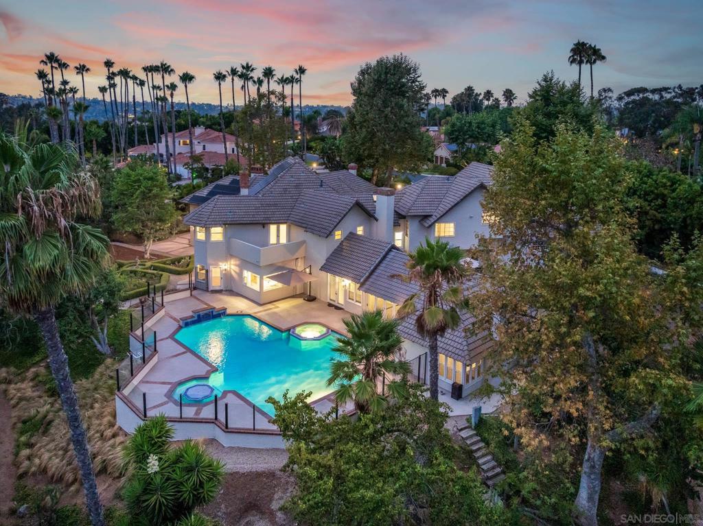 Nestled at the end of a peaceful cul-de-sac on the sought-after north side of Fairbanks Ranch, this enchanting 1.7-acre estate pairs classic European charm with relaxed California luxury. This elegant Country French residence enjoys sweeping views of the San Dieguito Valley and offers a seamless blend of style, privacy, & resort-inspired amenities. Inside, discover light-filled living spaces, soaring ceilings, & expansive La Cantina doors that open wide for true indoor/outdoor living—ideal for both intimate gatherings and large-scale entertaining. The backyard is a private oasis, complete with a sparkling pool & swim-up bar, built-in BBQ under roof and a full guest cabana with its own fireplace and bath. Inside, you’ll find timeless touches including a subterranean wine cellar and tasting room, a well-appointed office, and a vintage-inspired bar. The spacious primary suite features its own fireplace and two oversized walk-in closets, while five additional bedrooms provide comfort and flexibility for family and guests. Other highlights include a large flat lawn, an orchard with mature fruit trees, and an expansive motor court—all thoughtfully designed for both beauty and function. Set within the prestigious, 24-hour guard-gated enclave of Fairbanks Ranch, residents enjoy access to world-class amenities including a scenic lake, an equestrian center with riding trails, tennis courts, clubhouse, and one of the most charming children’s parks in all of San Diego. As an added convenience, the property includes access to a walking path that leads directly to SSF school drop off.