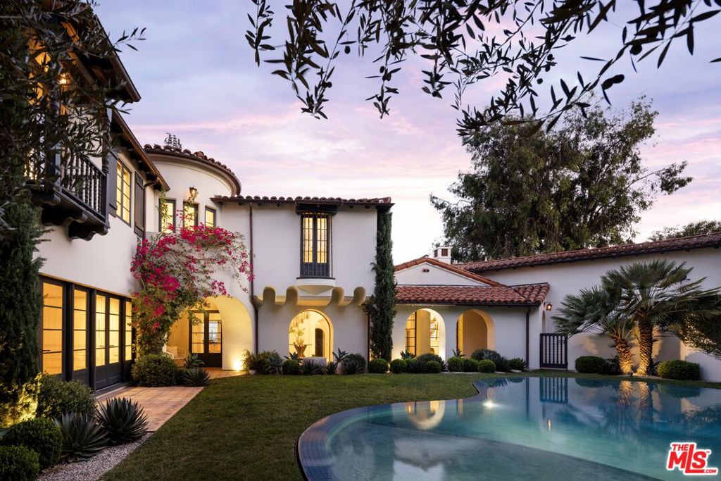 Perched in the hills of Los Feliz on a quiet cul-de-sac, Casa Vista is a reimagined 1928 Spanish Colonial that seamlessly fuses timeless architecture with sophisticated modern design and panoramic city views. A private compound situated behind solid gates - the home was rebuilt from the studs with all-new systems, high-end finishes, and meticulous attention to detail. Casa Vista exudes the romance of Old Hollywood with the ease of contemporary living. A formal entry opens to the main level, where a 13-foot ceiling living room with rebuilt fireplace and arched windows perfectly frame a view of downtown LA. The kitchen was completely redesigned during the renovation and features marble slab countertops with integrated sinks, custom European oak cabinetry, a 60" Wolf range, dual Miele dishwashers, a wine fridge, and a hidden coffee station. Upstairs, the primary suite captures sweeping skyline views and features a pitched ceiling, spa-inspired bath with a concrete soaking tub framed by an arched window, and generous custom closets. Additional bedrooms showcase Moroccan Zellij tilework, bespoke hardware, and thoughtfully designed finishes that pay homage to Hollywood's golden age of architecture. A central courtyard frames the residence with a newly rebuilt zero-edge pool and Baja shelf, surrounded by multiple terraces designed for lounging and dining. Outdoor amenities include a built-in BBQ, gas firepit, and lush landscaping with mature olive trees, Canary Island palms, and terracotta planters. The side garden features a tranquil fountain, while curated lighting and ficus hedging create privacy and ambiance throughout. Blending historic charm with modern elegance, this residence captures the very essence of California living. With its timeless architecture, private setting, and sweeping city-to-ocean vistas, this Los Feliz masterpiece offers a rare balance of architectural integrity and effortless sophistication - crafted for those who appreciate design, history, and the art of living beautifully.