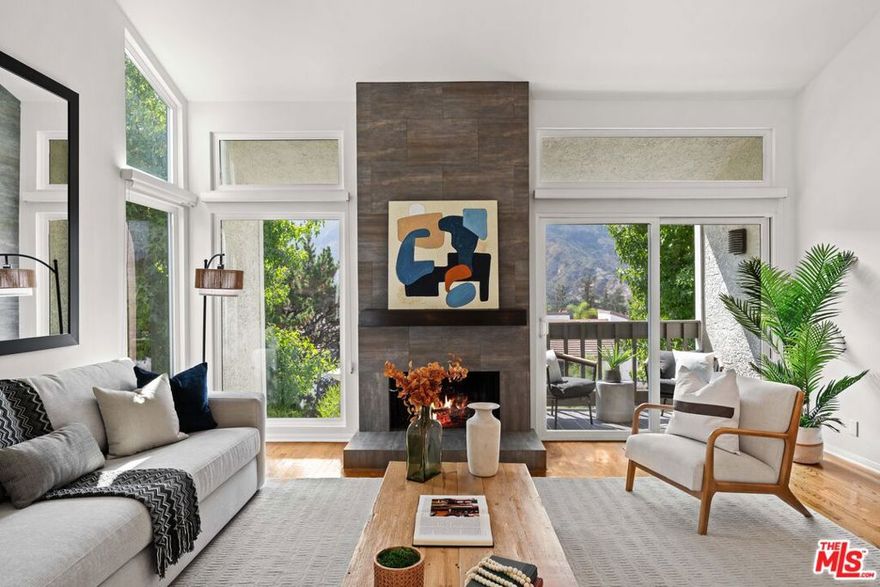 Tranquil Townhome with Sweeping Mountain Views! Nestled amid the Santa Monica Mountains, this spacious 2-bedroom, 2.5-bath townhome invites you to experience Pacific Palisades living at its finest. Sun-drenched interiors flow seamlessly to outdoor terraces, allowing you to savor treetop and mountain views from nearly every room. Upstairs, an open living and dining area with soaring ceilings and a cozy fireplace opens to a terrace framed by lush greenery and panoramic vistas. The eat-in kitchen combines style and functionality, perfect for morning coffee while overlooking the tranquil scenery, or hosting gatherings bathed in natural light. Downstairs, the primary suite and second bedroom share a beautiful wrap-around patio, offering sweeping mountain and treetop views. The primary suite features a walk-in closet and en-suite bath, creating a serene retreat. The second bedroom includes a built-in office area, ideal for remote work or study, and an adjacent full bathroom. Additional highlights include newly carpeted bedrooms, generous storage, and an attached two-car garage with laundry. Residents enjoy resort-style amenities: pool, spa, sauna, fitness room, and tennis courts, all set within beautifully landscaped grounds overlooking verdant hills. Located in the peaceful Palisades Highlands yet minutes from the Village, hiking trails, and the beach, this home blends natural beauty, convenience, and a lifestyle of calm sophistication. Experience mountain-view living in the heart of the Palisades-schedule your private tour today.