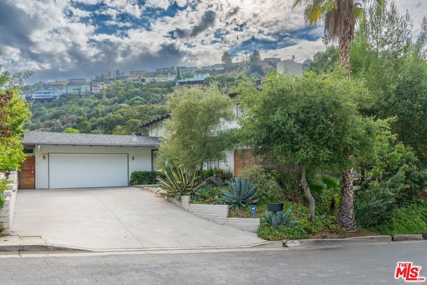 Your search for that perfect lower Nichols Canyon hideaway ends right here on Devista Drive where you will enjoy serene canyon views, great natural light and outdoor space for every time of day. Recently remodeled featuring 3 bedrooms (two with private balconies), 3 baths, a living and dining room that both open to the back patio, and a cook's kitchen designed for any level cook with ample counter space where you can easily entertain on any scale. Great storage and a direct entry garage. Designer details include high-end fixtures, custom cabinetry, French doors. Outdoor entertaining spaces include a large open patio surrounded by mature trees, a hot tub and custom gas fire-pit creating your own private oasis. Primary bedroom features a rolling barn door and picturesque balcony and a spa-like bathroom with dual sinks, soaking tub, and rainfall glass shower. This is quintessential Southern California living at its best you won't want to leave home. Close to Beverly Hills, Runyon Canyon, the Grove and World Famous Sunset Strip.