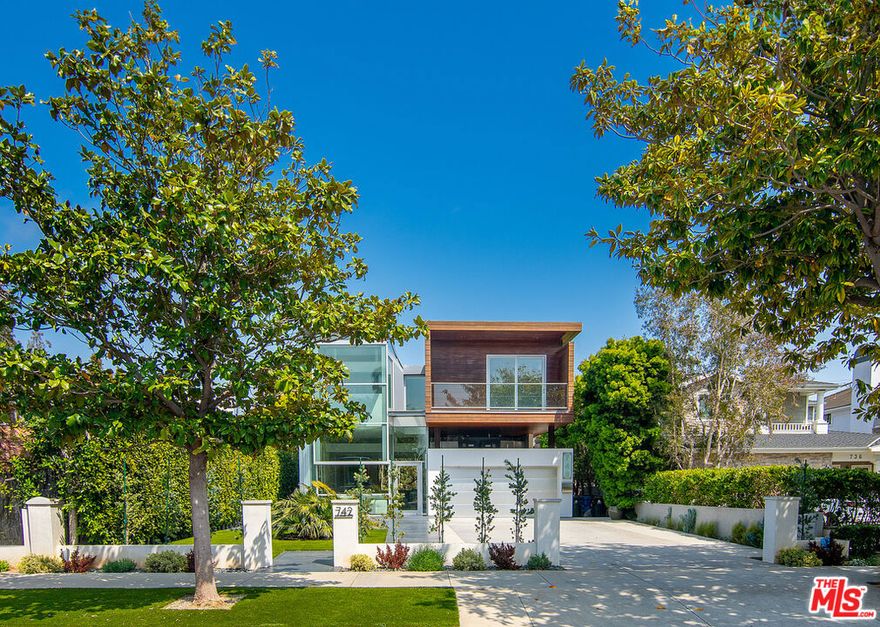 Presenting the Via De La Paz Residence, a stunning architectural home in the heart of Pacific Palisades.  Perfectly situated on one of the best streets, the home is nestled between the water and the mountains, short distance to the Pacific Ocean, the Bluffs, and the hiking trails of Temescal Canyon. In addition to its immediate proximity to a number of private and public schools, the La Paz Residence is minutes to the neighborhood's upscale Palisades Village, home to fine dining, boutique shops, movie theater, exercise studios, and grocery stores. The La Paz Residence offers the epitome of the Southern California fresh air indoor/outdoor living lifestyle. The all-glass front opens to soaring 13-ft. ceilings in an open floor plan that continues throughout the house and leads to beautifully customized floor-to-ceiling glass OTIIMA doors that span the entire width of the house.  The house includes a gourmet chef's kitchen with a massive 8' x 10' center island with seating for 6, all surrounded by premier appliances which include a BlueStar 10-burner gas stove top, a 6-ft. wide Dacor stainless steel Fridge/Freezer, double ovens, double warming trays, and four pull-drawer Fisher & Paykel dishwashers. The center island also includes two additional Sub-Zero under counter drinks drawers as well as significant storage space.  The home has 4 bedrooms and 1 office, all of which are ensuite. In addition, there is a detached below-ground en-suite living space, which can be used as guest quarters, office, music studio, games room, or additional entertainment room.