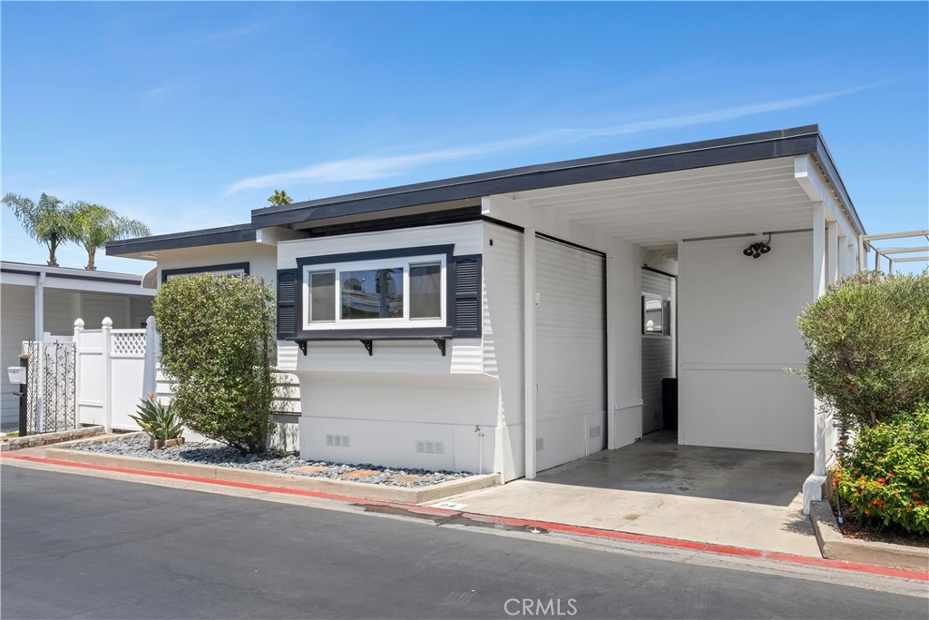 LENDER INCENTIVES - Welcome to your dream beach cottage in the heart of Newport Beach, nestled in the all-ages waterfront community of Bayside Village. This updated 2-bedroom, 2-bath manufactured home spans 1,029 sq ft and sits on one of the larger lots—offering a rare, private yard perfect for soaking up the Southern California sun. Inside, enjoy newer flooring, quartz kitchen counters, shaker cabinets, and a built-in wine fridge. The living space features crown molding, a cozy fireplace, and charming updated bathrooms. Step outside to a spacious yard with two storage sheds, shaded pop-up cover, and plenty of room for lounging or dining al fresco. There are 2 kayaks included for a turnkey beach retreat. Bayside Village offers exclusive access to a private beach, kayak launch, and scenic bike trails, along with two resort-style clubhouses. Residents enjoy two pools, two spas, BBQ areas, fire pits, multiple pet zones, and a fully fenced dog park. The North Clubhouse includes a fireplace, kitchen, and lounge area with iPad-ready stereo, while the South Clubhouse features a fireplace, dance floor, fitness rooms, and upstairs billiards. Just off PCH, you’re minutes from Balboa Island, Fashion Island, top beaches, and fine dining. The community borders a 220-slip marina and is near Newport Dunes, Back Bay View Park, and Bayside Drive Park. An active HOA hosts year-round social events, creating a true sense of community. Whether full-time or a weekend getaway, this is Newport living at its finest. We are offering lender incentives on this home in order to make your dream come to reality.