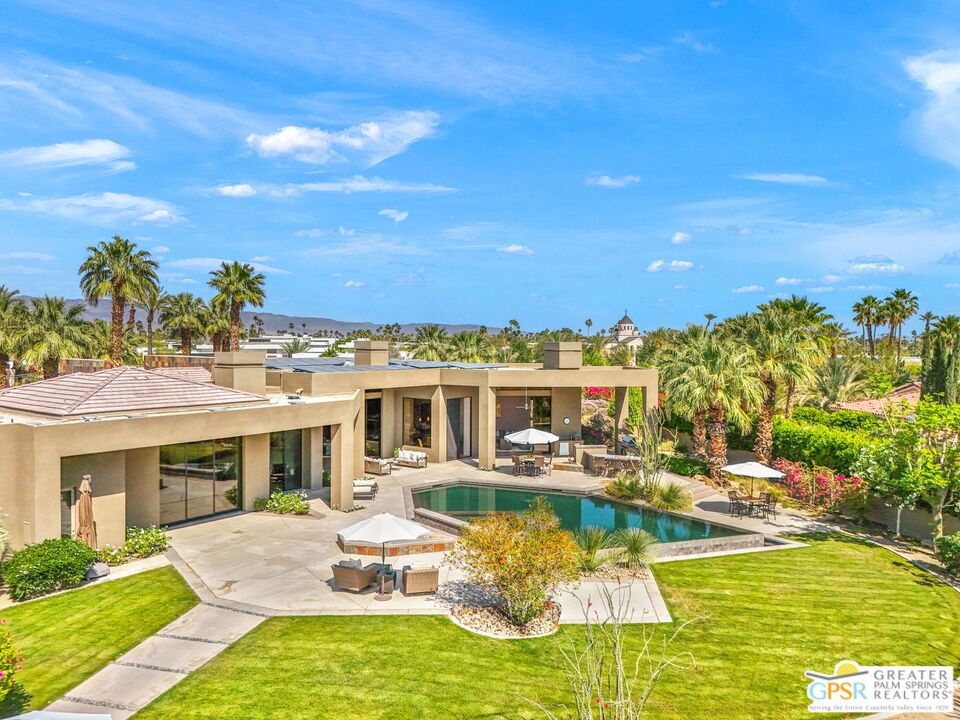 Welcome to 4 Paradise Cove Court, a 5-bedroom, 5.5-bath desert contemporary home with detached casita, situated on 1.12 acres in prime Rancho Mirage. This walled and gated estate features tall ceilings, floor-to-ceiling glass, and panoramic mountain views from nearly every room. Multiple outdoor living spaces include a south-facing infinity pool and spa, outdoor kitchen and bar, covered patio, and spacious pool terrace designed for effortless entertaining.Art collectors will appreciate the soaring ceilings and expansive walls, entertainers will be inspired to host both indoor and garden parties, car enthusiasts will love the gated motor court and three-car garage, and everyone will benefit from the 63-panel solar system that offers impressive energy efficiency!Formal entry framed by elegant fountains, sets a magical tone and leads into a dramatic living room with a striking fireplace, destination-style wet bar, and folding glass walls that open completely to the outdoors. The views are magical! The adjacent dining room with oversized wine refrigerator is ideal for special occasions and is adjacent to the chef's kitchen which includes a sous-chef sink, dual refrigerators, dual dishwashers, two convection ovens, a warming compartment, counter seating, and a casual dining area. You will love how it opens to a large great room that offers panoramic views and sliding glass doors that create a true indoor/outdoor experience! Primary Ensuite offers high ceilings, mountain views, direct access to the pool terrace, dual walk-in closets, and an oversized spa-like bath with split vanities, a soaking tub, and walk-in shower. The adjoining executive office features custom built-ins, fireplace, and direct outdoor access. Junior Ensuite Two is located off the main hall and continues the theme of walk-in closets and generous baths. Junior Ensuites Three and Four are privately situated in their own wing. The detached casita (Junior Ensuite Five) enjoys views of the grounds and offers two entrances, private patio, kitchen, spa-style bath, and walk-in closet.Take the Matterport Virtual Tour for a closer look at the flow and details of this exceptional home.