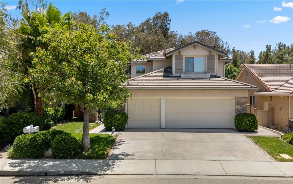 NO Mello-Roos | LOW HOA | Prime Valencia Location! Located in one of Valencia’s most desirable neighborhoods, this 4-bedroom, 3-bathroom home offers comfort, privacy, and convenience—just steps from top-rated schools, paseos, and fantastic community amenities. Inside, you'll find vaulted ceilings and abundant natural light throughout. The kitchen features granite countertops, a walk-in pantry, and newer appliances. It opens to a bright family room with a stone fireplace, large windows, and direct access to a beautifully landscaped backyard—spacious enough to add a pool and ideal for gatherings or quiet relaxation. This home offers a flexible layout, including a full downstairs bedroom and bathroom—perfect for guests, multigenerational living, or working from home. The bedroom is currently being used as a home office, offering a quiet space with great natural light. Enjoy enhanced privacy with no rear neighbors, as the property backs to the peaceful Valencia paseos. Upstairs, the primary suite features tranquil views, a private bathroom with dual vanities, a polished marble shower, soaking tub, and a walk-in closet with built-in drawers and marble flooring. Two additional bedrooms, a full bathroom, and generous hallway storage complete the upper level. The 3 car garage offers ample space for vehicles and storage, and includes attic access via a pull-down ladder. Community amenities include pools, hot tubs, a clubhouse, playgrounds, and scenic hiking trails. All this, plus proximity to shopping, dining, and entertainment, make this an ideal place to call home!