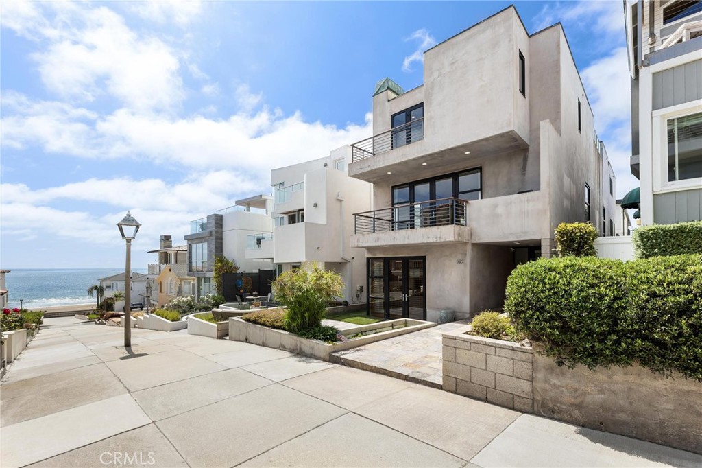 Located just a few homes from the sand, 129 20th Street presents a rare opportunity to live on one of the most desirable Walk Streets in all of Manhattan Beach, moments from the water and Downtown Manhattan Beach. This 4-bedroom, 4-bathroom south facing home spans approximately 4,570 square feet and offers the quintessential Southern California lifestyle. Entering from the picturesque Walk Street, you're greeted by a spacious ocean-view patio, an inviting space that sets the tone for relaxed coastal living. Ascending to the main level, enjoy an open-concept living space, anchored by a chef’s kitchen featuring a Sub-Zero refrigerator, stainless steel appliances and breakfast bar seating. Perfect for entertaining, the kitchen flows into the spacious living and dining areas. Large glass doors open to an oversized front-facing terrace that overlooks the charming Walk Street and offers incredible ocean views. Also on this level is a versatile bedroom, ideal as a guest room, home office, or den—complete with its own private terrace, a generous walk-in closet, and convenient access to the full hallway bathroom with a glass-enclosed shower. Upstairs, the landing leads to a tiered rooftop deck designed to maximize sweeping ocean vistas and direct views of the Manhattan Beach Pier, offering space to lounge, dine, and entertain. The primary suite is thoughtfully positioned to enjoy ocean views, featuring a private ocean-facing terrace, a fireplace, a spacious ensuite with double vanities, a soaking tub, glass-enclosed shower, and a custom walk-in closet. A secondary upstairs bedroom also enjoys its own private ocean-view terrace, walk-in closet, and ensuite bath. On the Walk Street level, enjoy a large media room/family room with a built-in wet bar, bathroom and access through glass doors to the front Walk Street patio. This level also includes an additional bedroom with custom built-ins, a laundry room, and direct access to the 3-car garage + 2-car driveway, totaling parking for 5 cars. With its spacious layout, multiple outdoor spaces, ocean views and prime location moments from the beach, 129 20th Street captures the essence of coastal Manhattan Beach living. **TERMS: offered unfurnished, 5 car parking, has AC, looking for August Start, term of 12 months or longer, tenant pays utilities.