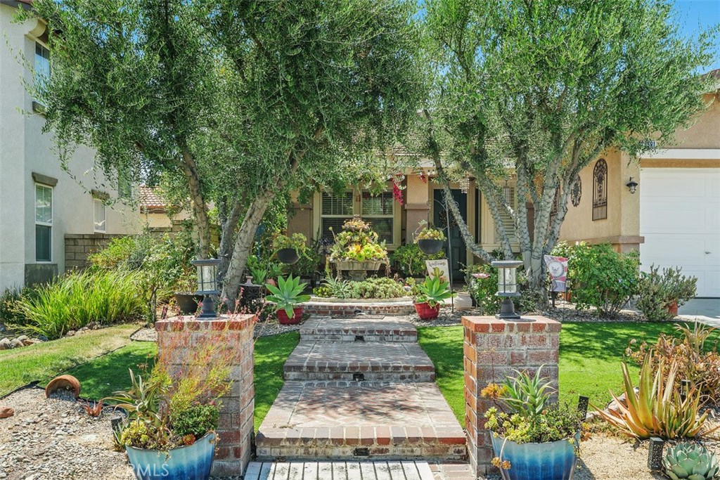Welcome to this beautifully maintained 4-bedroom, 2-bathroom home, offering 2,274 sq. ft. of comfortable living space on an expansive 11,326 sq. ft. lot. A brick-lined walkway, framed by lush greenery, leads you inside, where natural light fills the spacious open living and dining areas, perfect for entertaining or enjoying family gatherings.
The heart of the home is a vibrant and inviting kitchen, featuring striking blue cabinetry that adds a modern pop of color against warm granite countertops and a full backsplash. A large center island with a modern stainless steel sink offers additional prep space and a breakfast bar, making it ideal for both everyday meals and socializing. Stainless steel appliances, including a built-in microwave and gas cooktop, provide both style and functionality, while abundant cabinetry ensures ample storage. The open layout seamlessly connects the kitchen to the family room and dining area, where a cozy tiled fireplace invites relaxation. You’ll also find a versatile den, perfect for a home office or creative space.
The primary suite offers a peaceful retreat with a remodeled, spa-like bathroom, complete with a dual-sink vanity, a walk-in tiled shower, and a generous walk-in closet. Three additional bedrooms share a full bathroom with dual sinks, and a well-appointed laundry room with built-in cabinetry adds everyday convenience.
Recent upgrades include tile flooring throughout, a water heater, and an AC unit. Step outside to the oversized backyard, designed for both relaxation and entertaining, featuring low-maintenance turf, a covered patio, a built-in BBQ, and multiple seating areas. A 3-car garage offers abundant storage.
Conveniently located minutes from the 15 Freeway, top-rated schools, shopping, dining, and all that Murrieta has to offer, this home is move-in ready and full of style.
Don’t miss the opportunity to make this stunning property your own! Schedule your private showing today!