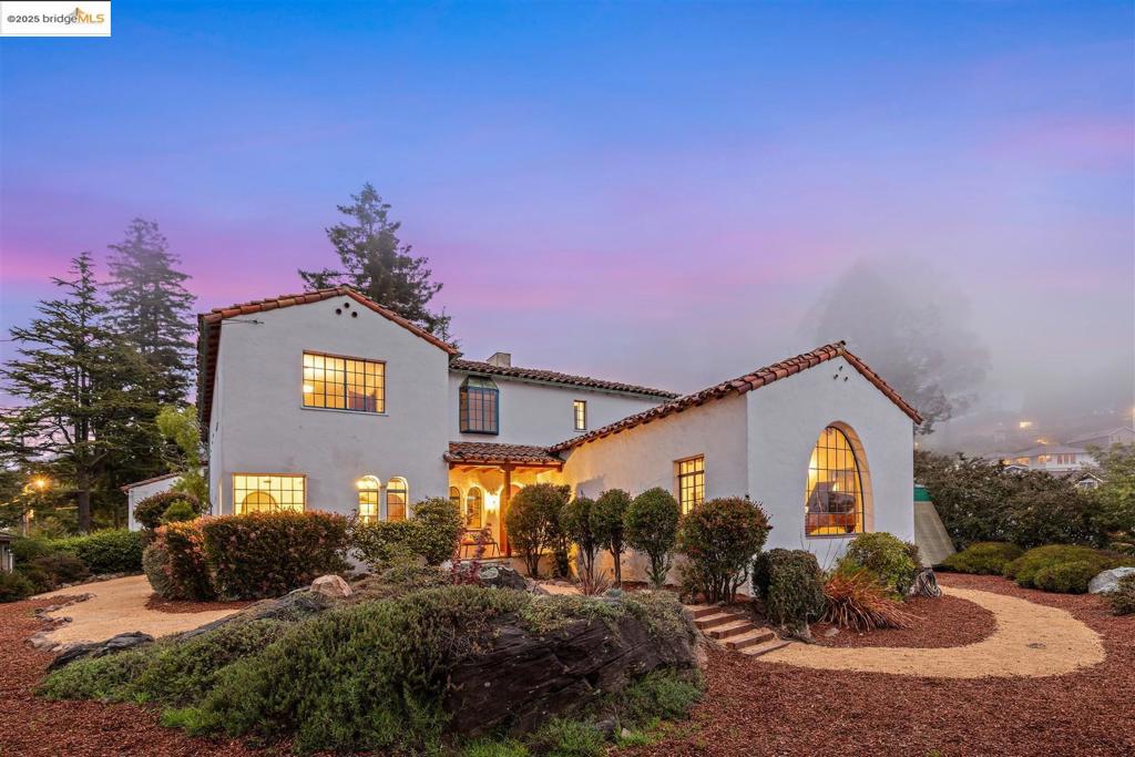 Located in the Berkeley hills just minutes to Solano Ave's many renowned attractions, this exceptional 1929 Spanish Colonial Revival home offers unparalleled views, beautifully preserved original details, unusually spacious square footage, and a thoughtfully designed detached ADU. Situated on nearly one-third acre, the 2-story primary home features 5BR, 3BA, formal living + dining rooms, a library/home office (potential 6th BR), and an eat-in kitchen, while the ADU includes a kitchen, one full BA + a flex room that converts to a BR with a built-in Murphy bed. Unobstructed western panoramic views encompassing the San Francisco Bay & city skyline, Oakland and the Bay Bridge & beyond are visible from many rooms in the home, the outdoor decks + patios, & the ADU. Original decorative details throughout include arched doorways + doors, white plaster walls, hardwood floors, decorative terra cotta tiles, fabulous wrought iron railings & light fixtures, wood-beamed ceilings and an impressive living room fireplace beneath an artful tile mural. Two main floor BRs + 3 upstairs BRs, all well sized. The BAs maintain the original 1920s colorful Art Deco tiles--beautiful! Grand Berkeley estates with this much original detail, and in this condition, rarely come to market. A truly stunning home.
