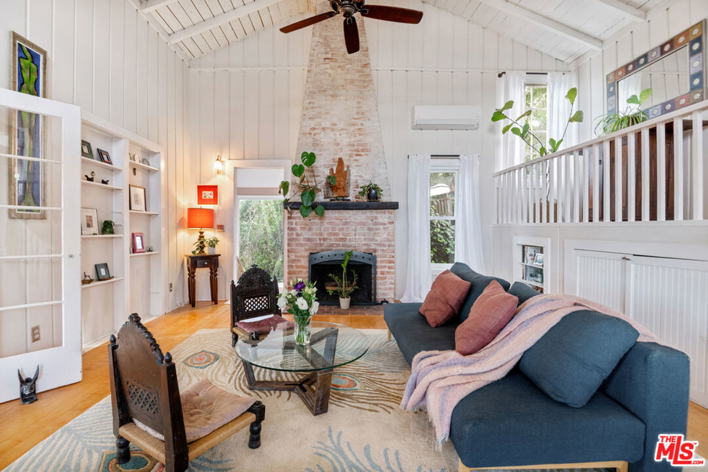 Nestled on a quiet street, this enchanting vintage cottage blends original character with modern comfort. A true gem of Topanga, this home features a dramatic two-story handcrafted brick fireplace, soaring high ceilings, and beautiful wood floors and ceilings throughout. The updated kitchen boasts local art tile and custom cabinetry, offering a perfect blend of rustic and contemporary. With a separate romantic master suite and a spacious loft, ideal for a meditation area or creative space, this home offers plenty of room to relax and unwind. The den is the perfect setting for a home office with attached balcony for those coffee breaks in between. The expansive entertainment deck off the living area downstairs is perfect for hosting guests, while the lovely garden areas provide a serene retreat. Enjoy ocean breezes, mountain views and the ultimate privacy in this peaceful setting. A bonus are the solar panels and backup batteries bringing this home int eh 21st century. Don't miss your chance to own a piece of Topanga's rich history in this unique and private mountain retreat.