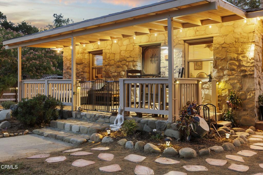 Nestled beneath a canopy of majestic oak trees, this charming 1930s stone cottage is a captivating blend of rustic beauty and timeless appeal. From the moment you step inside, an open floor plan draws you into the heart of the home, where a gourmet eat-in kitchen offers the perfect setting for cooking and entertaining. The living room radiates warmth with its striking river rock wood-burning fireplace, beautifully complemented by wood-style floors. Two inviting bedrooms provide lovely retreats, each offering views of the expansive almost 3/4 acre property.Thoughtfully upgraded, the property includes a new septic system, guest quarters, updated electrical panel, new decking, fencing, mature trees, outdoor lighting, a dog run, carportand so much more. Whether you're seeking quiet relaxation or lively recreation, this property has it all. Enjoy endless fun with your own pickle ball court, putting green, horseshoe pit, and additional outdoor amenities designed for entertainment and enjoyment. An attached one-car garage adds convenience, while the idyllic location just minutes from Lake Casitas and downtown Ojai offers the perfect balance of nature and modern living. This is countryside charm at its finest!