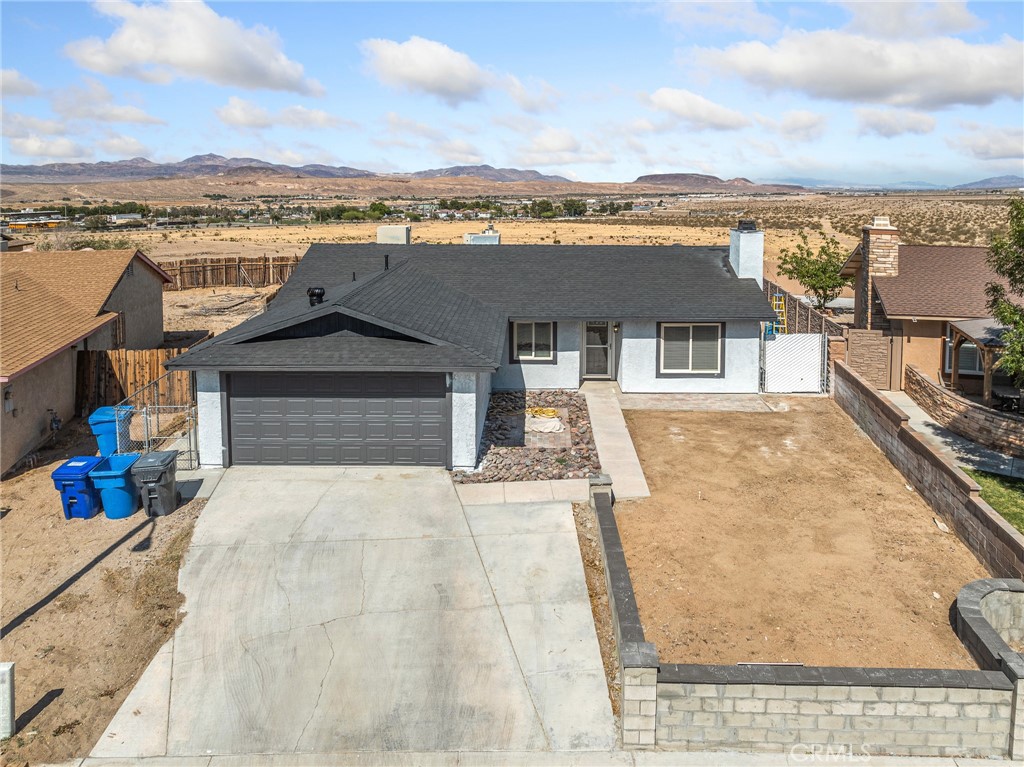 Don't miss your window of opportunity!!! This beautiful 3-bedroom, 2 bathroom home offers stunning desert views and is conveniently located near shopping centers, and major freeways. The interior features updated flooring, fresh paint inside and out, remodeled bathrooms, and a cozy fireplace in the living room. Enjoy peace of mind with a new roof. making this home move-in ready and perfect for comfortable living.