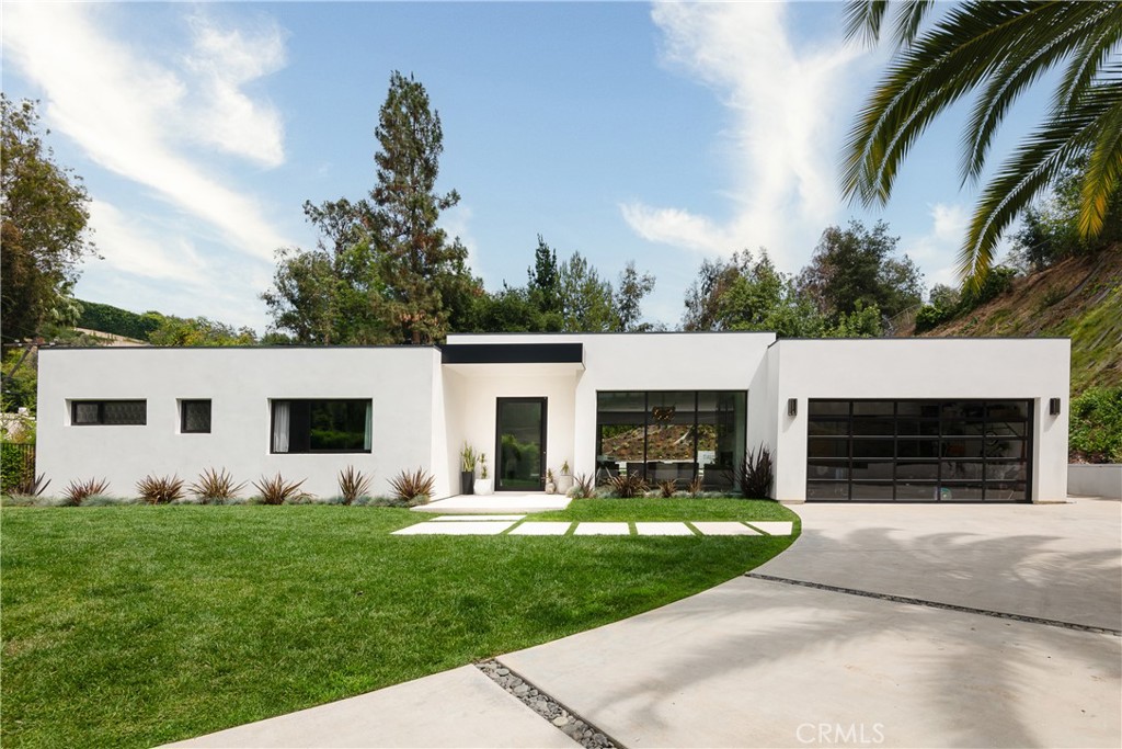 Welcome home to 9924 Liebe Drive, an ultra-modern sanctuary tucked into the serene and coveted Beverly Crest neighborhood of Beverly Hills. Located behind private gates, this single-level dream home was flawlessly built in 2018 boasting 3 bedrooms, 4.5 bathrooms on an expansive and secluded 60,804 sqft lot. Designer-perfect from top to bottom, this fully custom oasis features 11 foot high ceilings, an abundance of natural light through four large skylights, Fleetwood door package, black oak herringbone floors, Italian cabinetry, Rimadesio glass doors and marble finishes throughout. The spacious primary bedroom includes a walk-in closet and en-suite bathroom with heated flooring. A gourmet chef’s kitchen houses Wolf and SubZero appliances, a warming drawer, in-island refrigerated drawers and double sinks for convenience. Floor-to-ceiling, 28 foot, sliding glass doors lend themselves to an indoor/outdoor luxury lifestyle where the main living area flows seamlessly to the tranquil backyard offering ample space for entertaining. A comfortable lounge area, pool with automatic cover for convenience and safety, and separate cabana with gym and full steam room create the perfect environment to enjoy year-round. This home is the definition of ‘style meets comfort’ offering residents luxe amenities including Tesla solar, an EV charging unit, Control4 Smart System that manages surround-sound speakers, security cameras, lighting, temperature and more; all from the convenience of your phone or one of the in-house tablets.