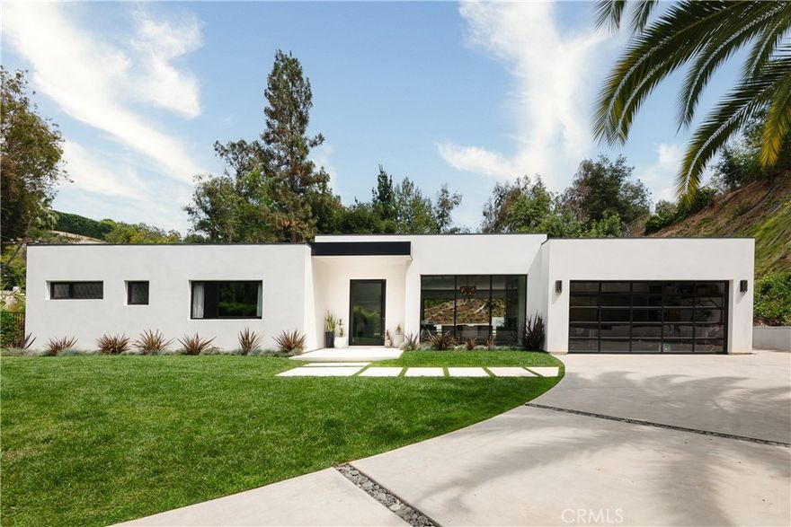 Welcome home to 9924 Liebe Drive, an ultra-modern sanctuary tucked into the serene and coveted Beverly Crest neighborhood of Beverly Hills. Located behind private gates, this single-level dream home was flawlessly built in 2018 boasting 3 bedrooms, 4.5 bathrooms on an expansive and secluded 60,804 sqft lot. Designer-perfect from top to bottom, this fully custom oasis features 11 foot high ceilings, an abundance of natural light through four large skylights, Fleetwood door package, black oak herringbone floors, Italian cabinetry, Rimadesio glass doors and marble finishes throughout. The spacious primary bedroom includes a walk-in closet and en-suite bathroom with heated flooring. A gourmet chef’s kitchen houses Wolf and SubZero appliances, a warming drawer, in-island refrigerated drawers and double sinks for convenience. Floor-to-ceiling, 28 foot, sliding glass doors lend themselves to an indoor/outdoor luxury lifestyle where the main living area flows seamlessly to the tranquil backyard offering ample space for entertaining. A comfortable lounge area, pool with automatic cover for convenience and safety, and separate cabana with gym and full steam room create the perfect environment to enjoy year-round. This home is the definition of ‘style meets comfort’ offering residents luxe amenities including Tesla solar, an EV charging unit, Control4 Smart System that manages surround-sound speakers, security cameras, lighting, temperature and more; all from the convenience of your phone or one of the in-house tablets.