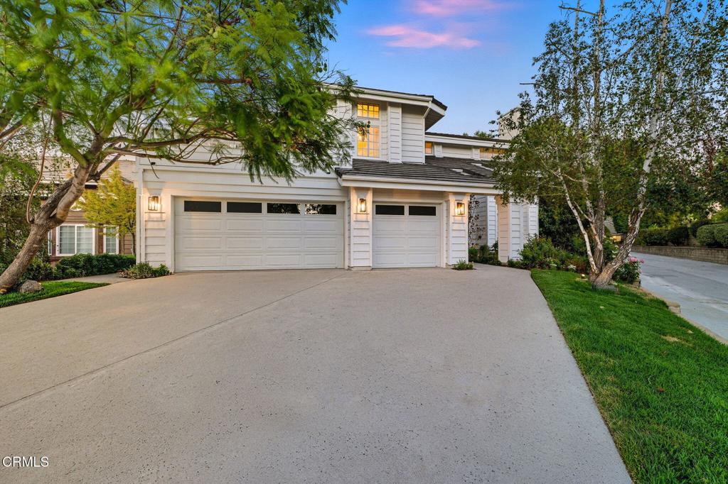 Tucked at the end of a quiet cul-de-sac in the heart of Agoura Hills, this beautifully refreshed Cape Cod home combines the charm and character of an established property with the feel of a brand-new space. Generously sized and thoughtfully updated, it's a rare opportunity to step into a home that is both move-in ready and full of potential to customize for years to come. Fresh paint, new carpet, updated lighting, and modern hardware bring brightness and style throughout. An expansive entryway welcomes you into the living room with high-ceilings and a fireplace, leading to the formal dining room and adjacent built-in bar. The refreshed kitchen shines with brand-new stainless-steel appliances, ample cabinet and counter space, a center island, and a bay window open to the backyard. An oversized dining area offers space for casual meals and gathering. The kitchen flows into a cozy family room, with a fireplace. Practical spaces round out the downstairs, including a powder room, two big closets, a laundry room, and direct access to the three-car garage with newly epoxy coated floors. A full downstairs bedroom suite with private backyard access adds flexibility -- ideal for guests, play space or a home office. Upstairs, there are three additional large bedrooms. Two share a Jack-and-Jill bath, and the third enjoys easy access from the hallway. A loft-style nook provides another space to customize as a study, play area, or reading corner. The primary bedroom is a true suite! This unique space is luxuriously oversized and offers the opportunity to create a completely personalized retreat with a sitting area with fireplace and balcony overlooking the backyard and mountain views. The spacious en-suite bathroom features dual sink vanity, high ceilings, a soaking tub, and both a walk-in and additional reach-in closets. Outdoors, refreshed landscaping highlights mature growth with a clean, colorful, updated feel. The backyard is designed for year-round enjoyment, featuring a pool and spa, grassy play space, a raised patio for lounging, a covered dining area, and a built-in BBQ for entertaining. Bright, spacious, and thoughtfully renewed, this gorgeous home offers the best of both worlds: the welcoming charm of an established home in a great location with the appeal of fresh and modern updates. Nestled in a sought-after neighborhood near award-winning Las Virgenes schools, parks, beaches and conveniences.