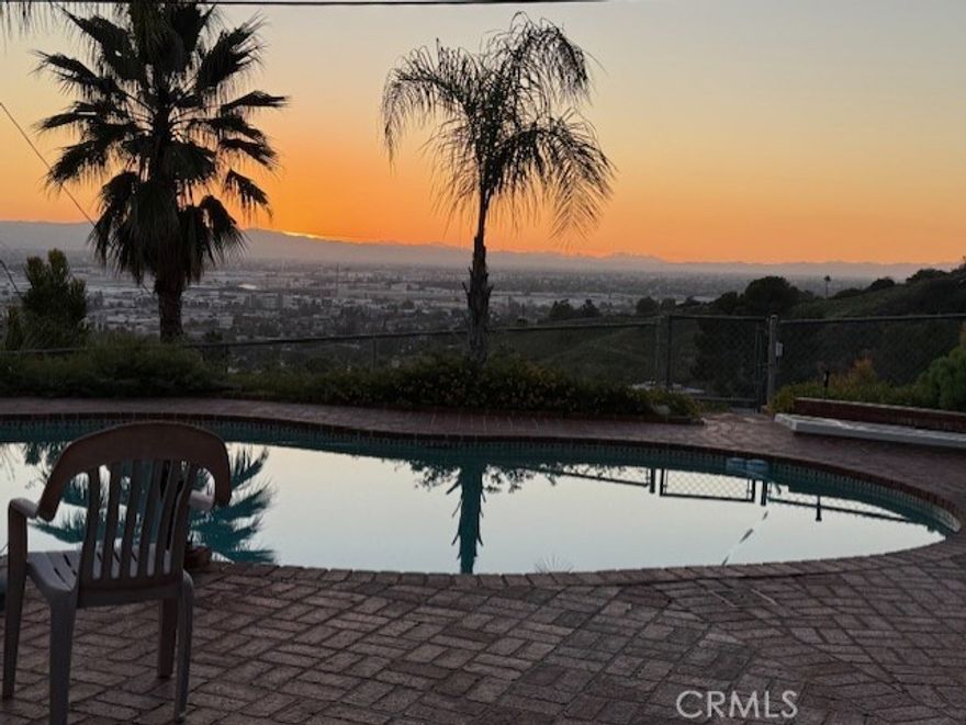 View, View, View!  Original Owners-First time EVER on the Market.  10,356 SF LOT with RV Parking! Located in the desirable Burbank Hills, this home offers sweeping city views and a private gated entrance. Situated at the end of a quiet cul-de-sac, this 5-bedroom, 3-bathroom pool and spa home is a must-see.  Enjoy a functional layout with four bedrooms upstairs and one conveniently located downstairs. The kitchen opens to a formal dining room, with sliding doors that lead directly to the sparkling pool—perfect for indoor/outdoor living.  The spacious living room features a cozy fireplace, while the den includes a wet bar and direct access to the pool area, ideal for entertaining.  A long paver driveway leads to a 3-car attached garage, with additional RV parking and ample off-street parking.  Don’t miss this rare opportunity to own a private hillside retreat with breathtaking views near Brace Park!