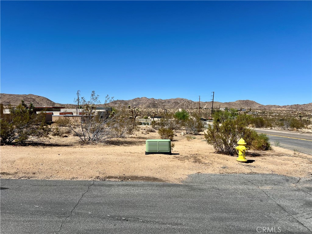 Presenting not just a vacant lot, but a beautiful- LAND OF OPPORTUNITY. This stunning (17,900sf) .41-acre parcel offers the perfect blend of serene desert escape and convenient access, boasting breathtaking panoramic views of the iconic valley and rugged mountains while being just minutes from the vibrant downtown and the gates of Joshua Tree National Park. This rare offering provides endless possibilities to build your personal dream home, a lucrative Airbnb retreat, or a weekend sanctuary, all on a massive, private lot. This is more than land—it's a foundation for your future, a guaranteed path to ownership, and the most compelling canvas for your vision you will find in Joshua Tree. Your dream home awaits, and it starts here.