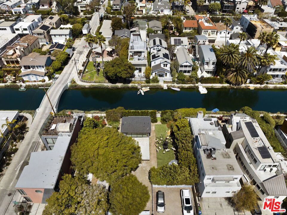 Nearing RTI plans and permits, 404 Linnie Canal is a special opportunity for someone looking to customize their own space on the world renowned Venice Beach Canals. Set in one of the premier areas within the Canals, the property has been issued LA City Coastal Commission permits for a 3,551 square foot home, plus garage and 732 square foot roof deck with a permitted pool/spa beautifully designed by noted Canal architect Austin Peters. Benefit from an expedited process: these plans/permits that will save you time and money while you focus on customizing the design to your lifestyle. New construction home sales on the Canals have soared, which allows you to design your dream home with the peace of mind that you will be sitting on equity once the project is completed. A true rare opportunity to live and become a part of the vibrant Venice Canal community where neighbors know each other and kids play outside in a peaceful beachside setting.