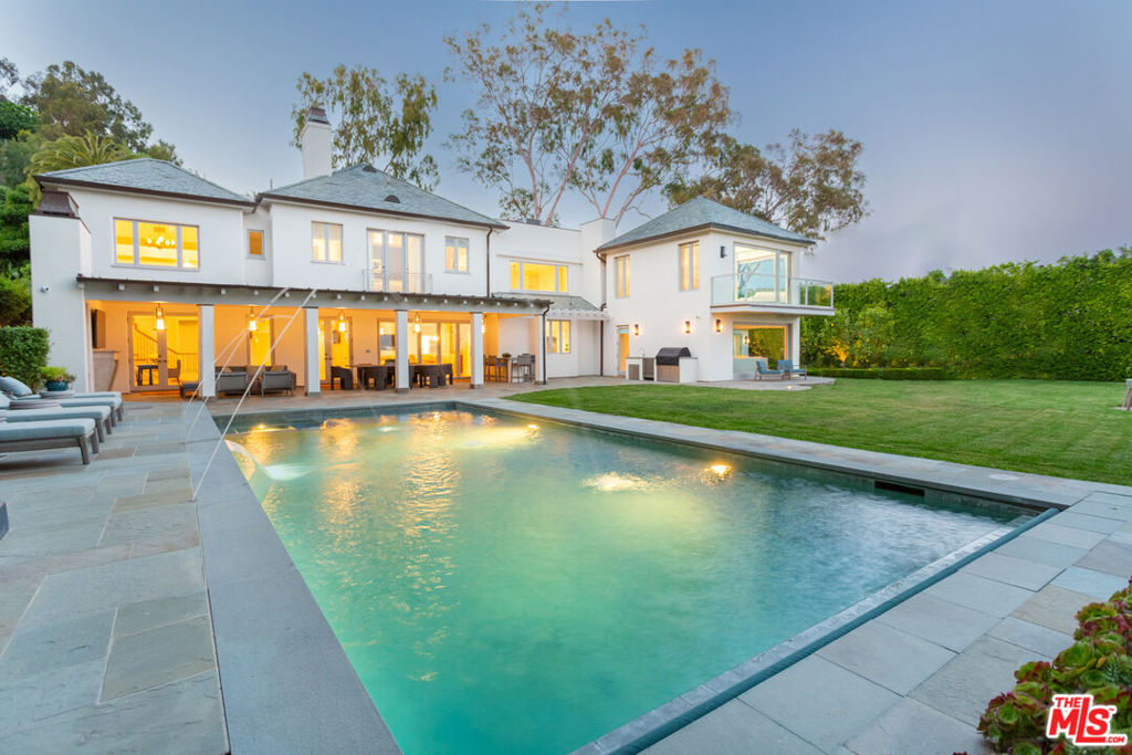 Ocean views and coastal elegance in the Pacific Palisades Riviera. Recently reimagined and remodeled by Errol Dejager Design, this private estate rests on over a half acre flat with expansive coastal and city views. Featuring inviting home spaces including four bedroom suites, as well as an additional guest bedroom, formal living and dining, family room, a voluminous office library wrapped in wood paneling, a custom dry sauna room, and an indoor/outdoor heated fireplace patio area that takes in the large pool, grassy private yard, and amazing head on views of the ocean, coastline, and Catalina Island. A truly spectacular property rarely available in LAs most exclusive neighborhood.