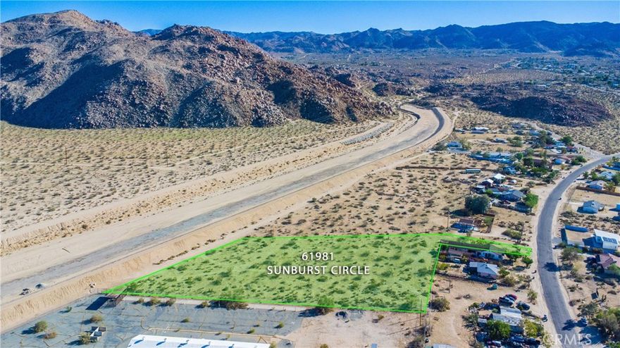 Nearly 2.5 Acres in Joshua Tree Village with Stunning Views. Discover the perfect opportunity to build your desert retreat on this prime 2.44-acre parcel located in the heart of Joshua Tree Village. Offering magnificent, views of surrounding mountains and desert landscapes, this property combines natural beauty with convenience. Situated just minutes from the Village’s vibrant restaurants, shops, and local art scene, and only 4 miles from the entrance to Joshua Tree National Park, this location is ideal for a vacation home, rental, or investment. Zoned for 4 units per acre (buyer to verify), the land offers excellent development potential, whether you envision multiple residences or a larger homestead. Utilities are nearby with gas, water, electricity available, all with paved road access, making development straightforward. Adjoining 1.88 acre parcel (MLS# JT25234693), and nearby 1.4 acre parcel (MLS# JT25234703) also available. With its rare combination of zoning flexibility, accessibility, and breathtaking scenery, this lot is a standout opportunity in one of the desert’s most desirable destinations.