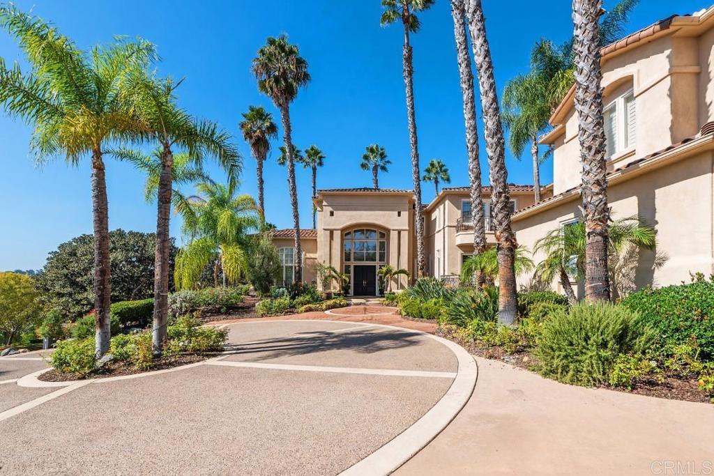 Grand and impressive fully furnished home with an abundance of curb appeal in the gated community of The Summit. Beautiful Mediterranean style villa with panoramic sunset, mountain and views beyond. Stunning sun splashed formal living room with floor to ceiling windows, French doors and stone fireplace, romantic formal dining room and executive office with lots of storage. Light filled gourmet kitchen with all professional appliances opens to the large family room with fireplace, informal dining and seating bar. An oversized and elegant second-story master suite with fireplace, expansive well-appointed cedar lined dressing room, spa bath and view oriented balcony provides the ideal venue for morning coffee or evening lounging, There are an additional 3 bedrooms, all well-appointed, a game room/siting lounge and gym all located on the second level. There is an additional bedroom suite with outdoor access located on the first level. French doors throughout allow for easy access for indoor/outdoor entertaining, with numerous covered loggias and patios. Outdoors one can enjoy the spectacular pool, spa and water features, a covered outdoor living/dining room, summer kitchen with bar seating, raised bed gardens, all surrounded by beautiful mature palms and landscape. Garage parking for 4 cars. Hickory Pecan and Creama-Marfil flooring. Designer details throughout. Completely private and situated on 2.02 acres. The Summit is a gated community of 22 custom designed and built homes. Very private and peaceful.