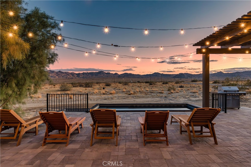 Fully functioning airbnb, private desert compound on two separate parcels totaling approximately 8.5 acres. Remodeled main home and separate free standing guest quarters in today's designer finishes. All furnishings are included right down to the linens. Featured by Architectural Digest. This special property known as the " The Drive In" is unique to the area offering a Drive-In Movie Theater (12'x20' Screen)+ Hot Tub + POOL with custom deck+ Built in BBQ + Outdoor Bar w/swings (amazing views of the mountains in the National Park)+ Fire Pit w/built in seating + Outdoor Table (For Dining Al Fresco)
+ Closest to the Pin Golf Hole (19th hole, 80 yards)+ 6 Hammock Circle (perfect for stargazing)+PICKLEBALL COURT+ Yoga Deck + Outdoor Stone Bathtub (with hot and cold water)+ Hook & Ring Game on Deck. IG account with almost 40k organic followers is included. Main house is permitted 2 bedrooms and casita is 1 bedroom allowing 2 separate short term rental permits for an occupancy up to ten. Main home is central a/c, casita is mini split. This is an amazing property !!!