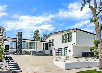 Settle into luxury living in a completely re-imagined single-family residence located in the beautiful and prestigious Prime Little Holmby neighborhood, just moments from Holmby Park and UCLA. This bright home features high ceilings, an excellent open floor plan, 3 Bedrooms, and 5 Bathrooms, with the Living Room (and fireplace) flowing seamlessly into the Dining area and the large chef's kitchen. Both the kitchen and the Family Room open directly to the private backyard for easy entertaining, while the luxurious Primary Bedroom offers a true retreat with its own fireplace, walk-in closet, and a spa-like bath featuring a soaking tub and separate shower, all opening to the backyard. Completing this remodeled residence are two additional bedrooms, each with a private en-suite bath, a powder room, and a separate laundry room. Two-car garage attached.