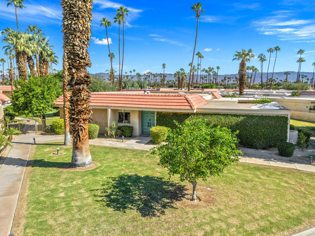 Mid-Century modern furnished Condo built in 1967 designed by legendary architect William Krisel who helped define famous Palm Springs modern architecture. This Indian Wells Country Club Sandpiper Condo has fantastic location, 2 bedrooms, 2 bath, large atrium patio, 2 car garage and 1864 Sq. Ft. of interior living with extended patio overlooking the beautiful pool and mountain views. Walk into light and bright open floor plan with high ceilings, wall of glass sliders in the spacious Great Room, high ceilings, stone fireplace, and built-in custom cabinetry galore. Formal Dining area with views. Kitchen has picturesque south mountain views, light countertops, white appliances, informal wet bar, and seating. Light tile floors throughout; carpets in the bedrooms. Primary Bedroom with walk-out private atrium and mountain views. Primary Bath has light countertops, dual sinks, big walk-in closet, large vanity, and separate toilet area with tub/shower. Guest Bedroom has walk- in closet, and ensuite bath with white tiled shower. Large Laundry Room for extra storage. Enjoy the privacy of Indian Wells Country Club!