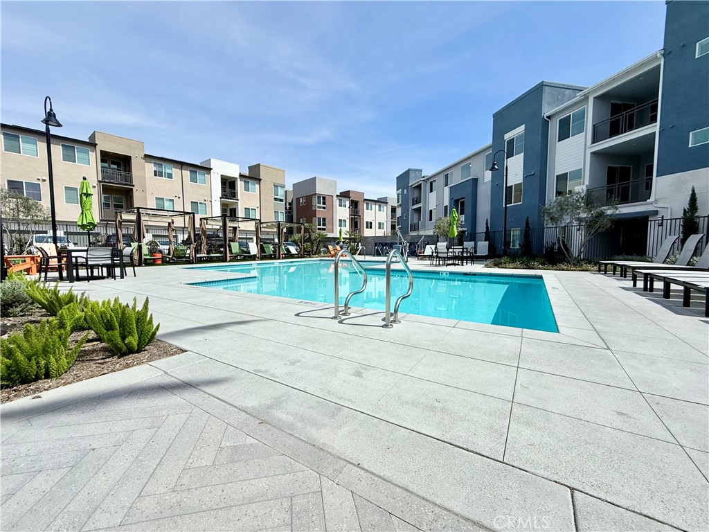 Welcome to this beautiful home!!! A luxurious 3rd-floor condo in the heart of Ontario. This 1 bedroom, 1 bathroom home offers upgraded living space with luxury laminate flooring throughout the house, a beautiful kitchen with an island, one car garage,, balcony, laundry room, beautiful resort-style pool with cabanas including barbecue areas. The prime location ensures easy access to shopping, dining, top-rated schools, and major freeways, making commuting and outings effortless. Built in 2024 offering a move-in-ready home in a vibrant, amenity-rich neighborhood. Experience the best of modern living.